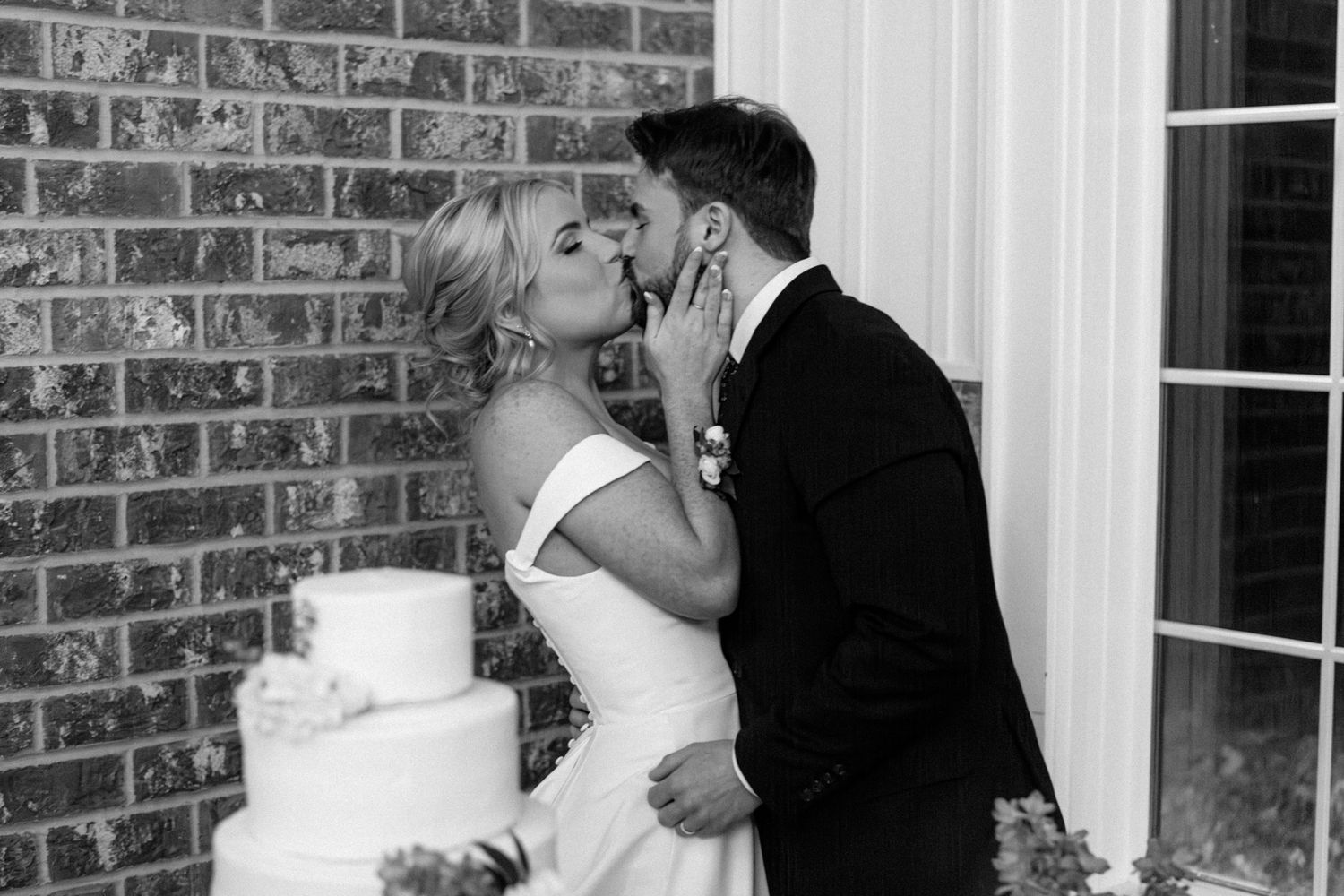 Bride and groom share a joyful wedding cake cutting moment at Silo Farm, captured by Joia Lyn, a Kentucky wedding photog