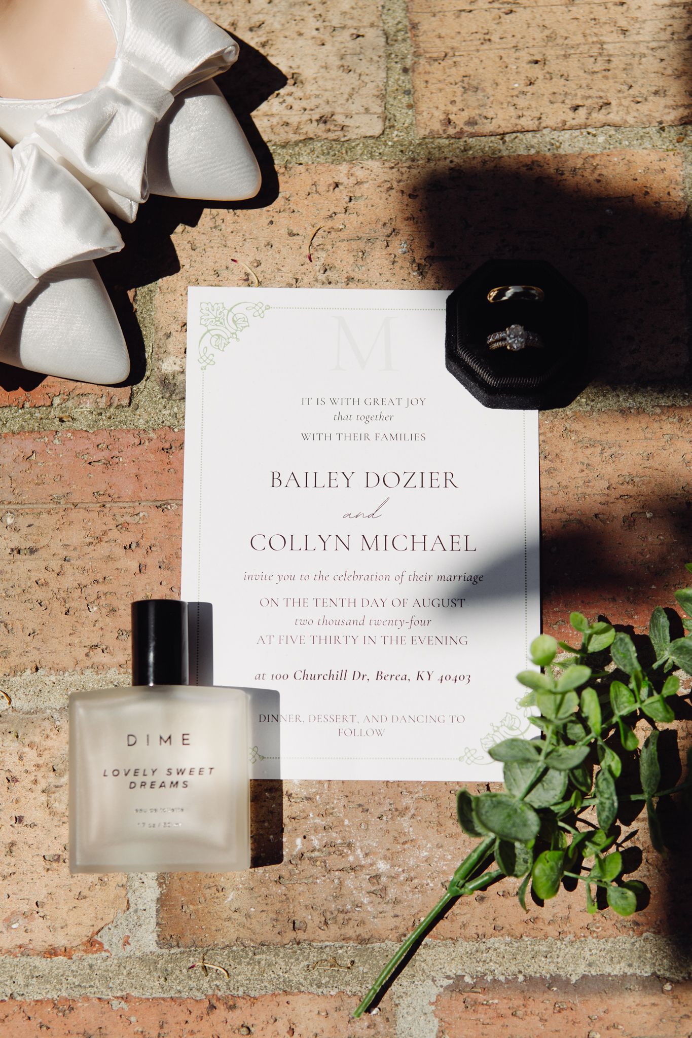 A wedding invitation displayed alongside elegant shoes and a sparkling wedding ring, symbolizing love and celebration.