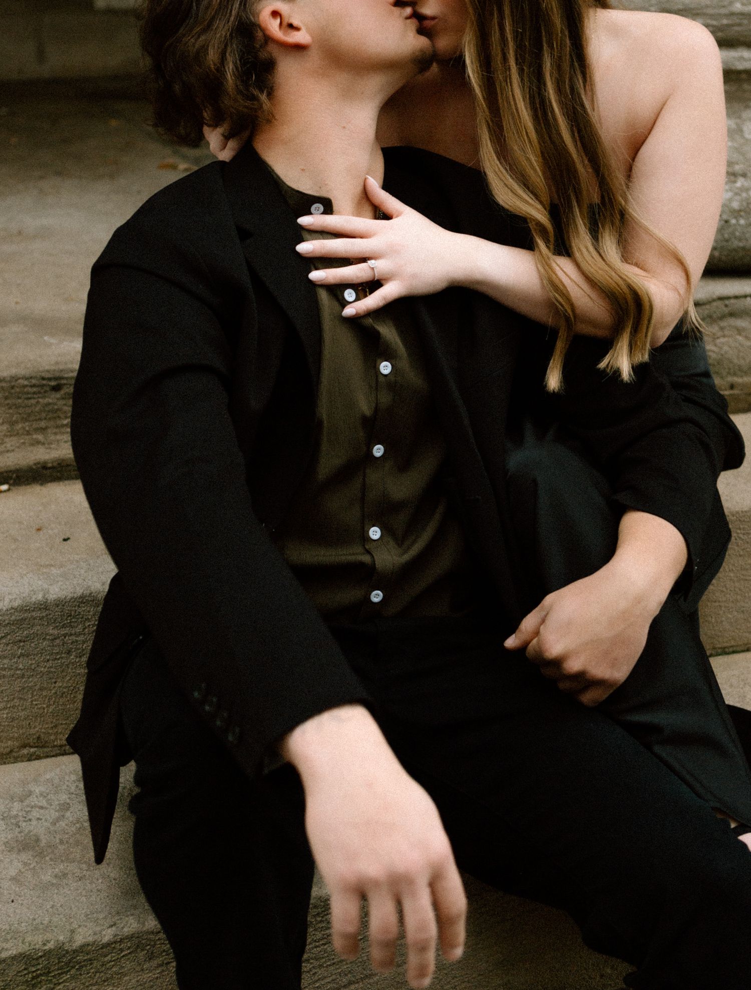 photo of an engaged couple embracing, sharing an intimate moment in downtown Louisville