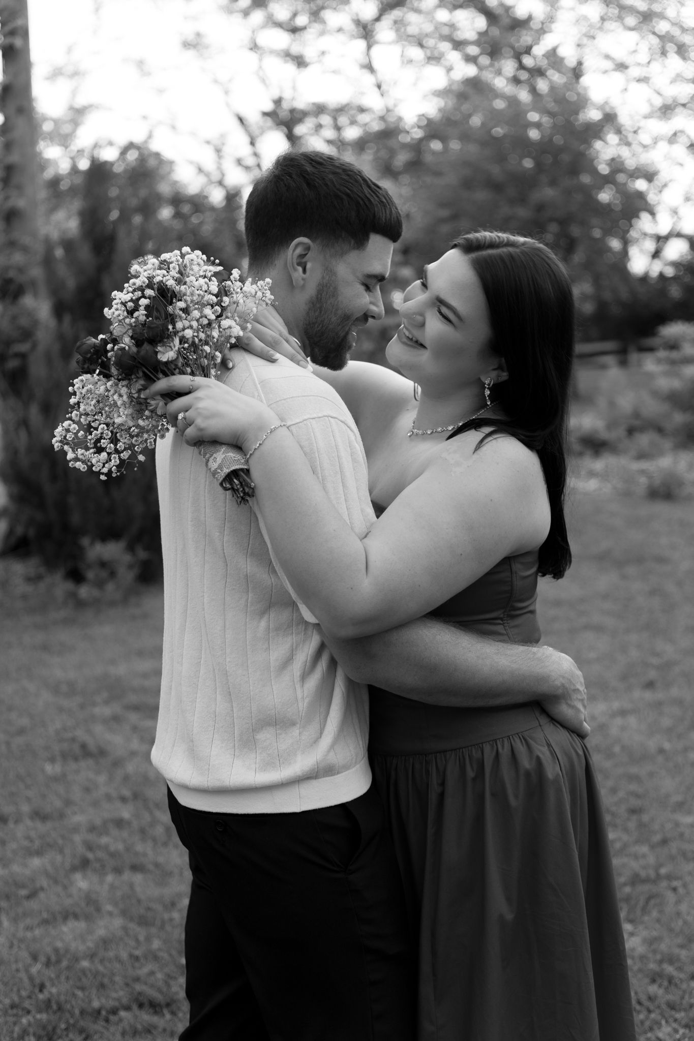 Black and white photo series capturing intimate dance poses in outdoor garden setting.
