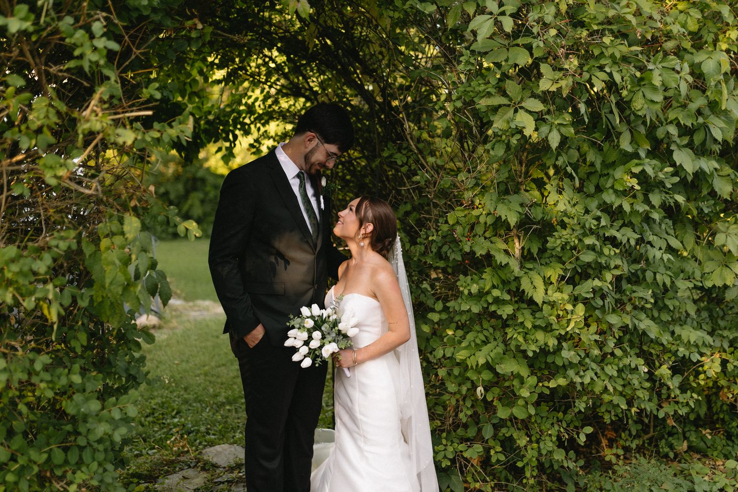 Romantic outdoor wedding photo of the bride and groom in a grassy field