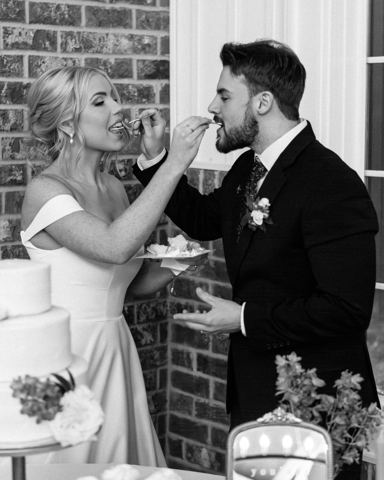 Bride and groom share a joyful wedding cake cutting moment at Silo Farm, captured by Joia Lyn, a Kentucky wedding photog