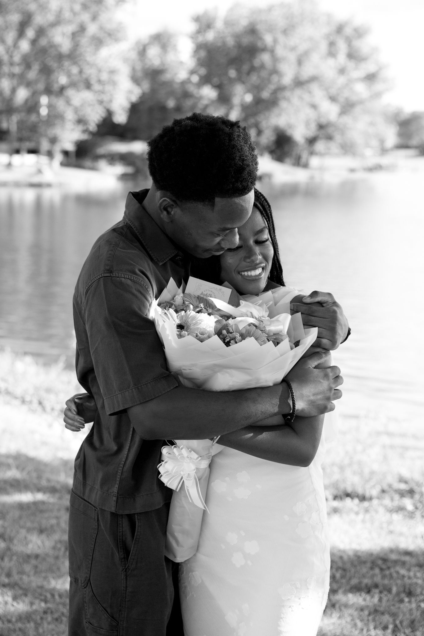 Joyful moment as Belle says yes to Chadrack's proposal by a peaceful lake in Kentucky.