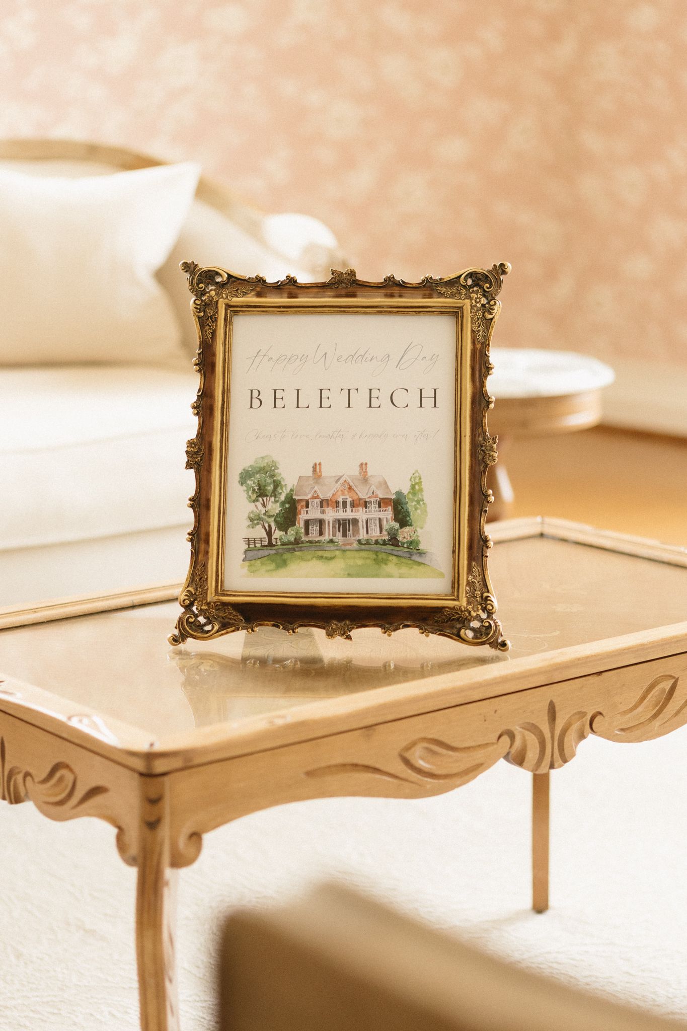 Small framed watercolor artwork displays on decorative stands showing architectural renderings in muted sepia tones.