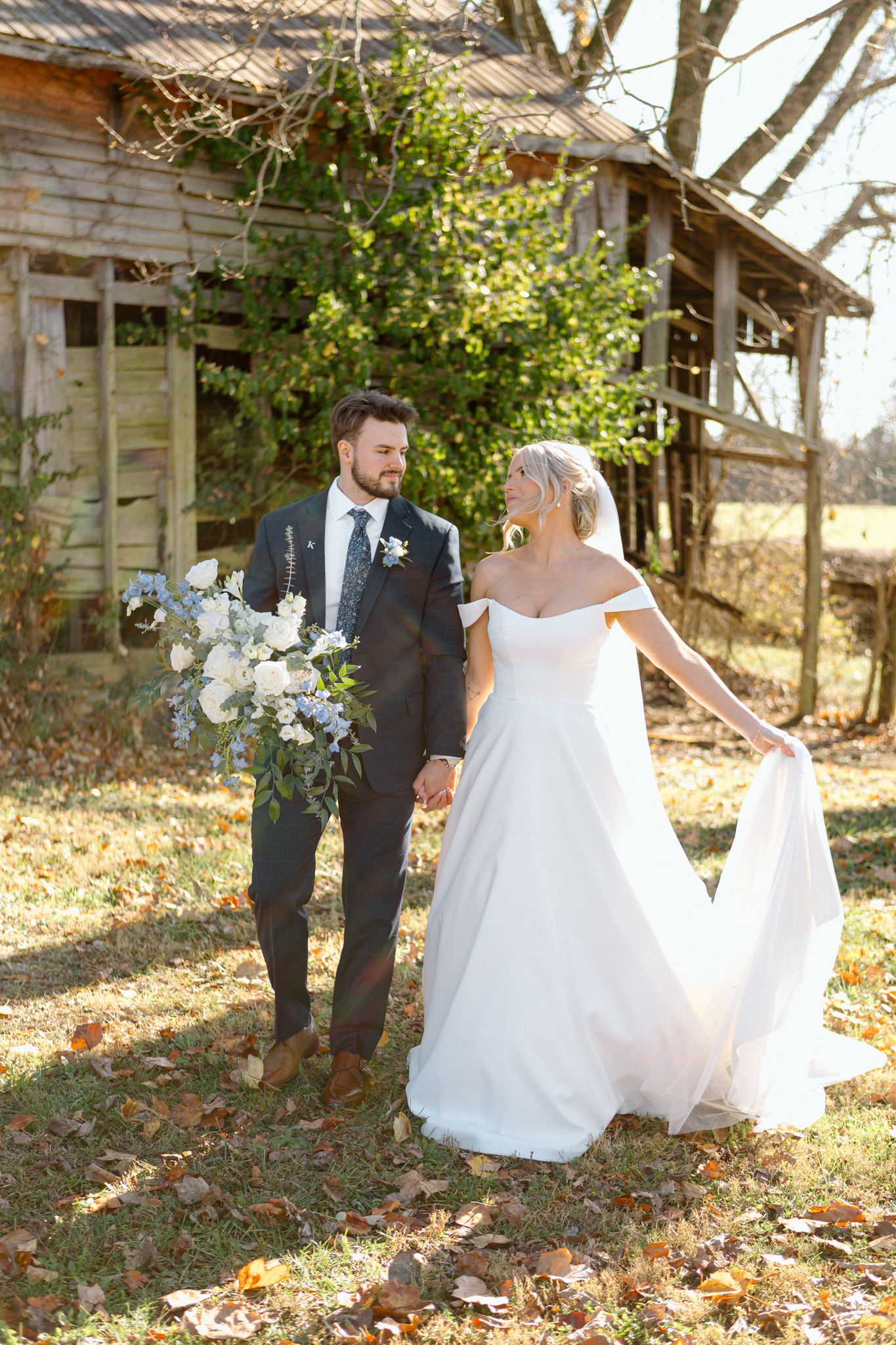 Bride and groom posing with a lush bouquet at Silo Farms. Photo by Joia Lyn, KY wedding photographer