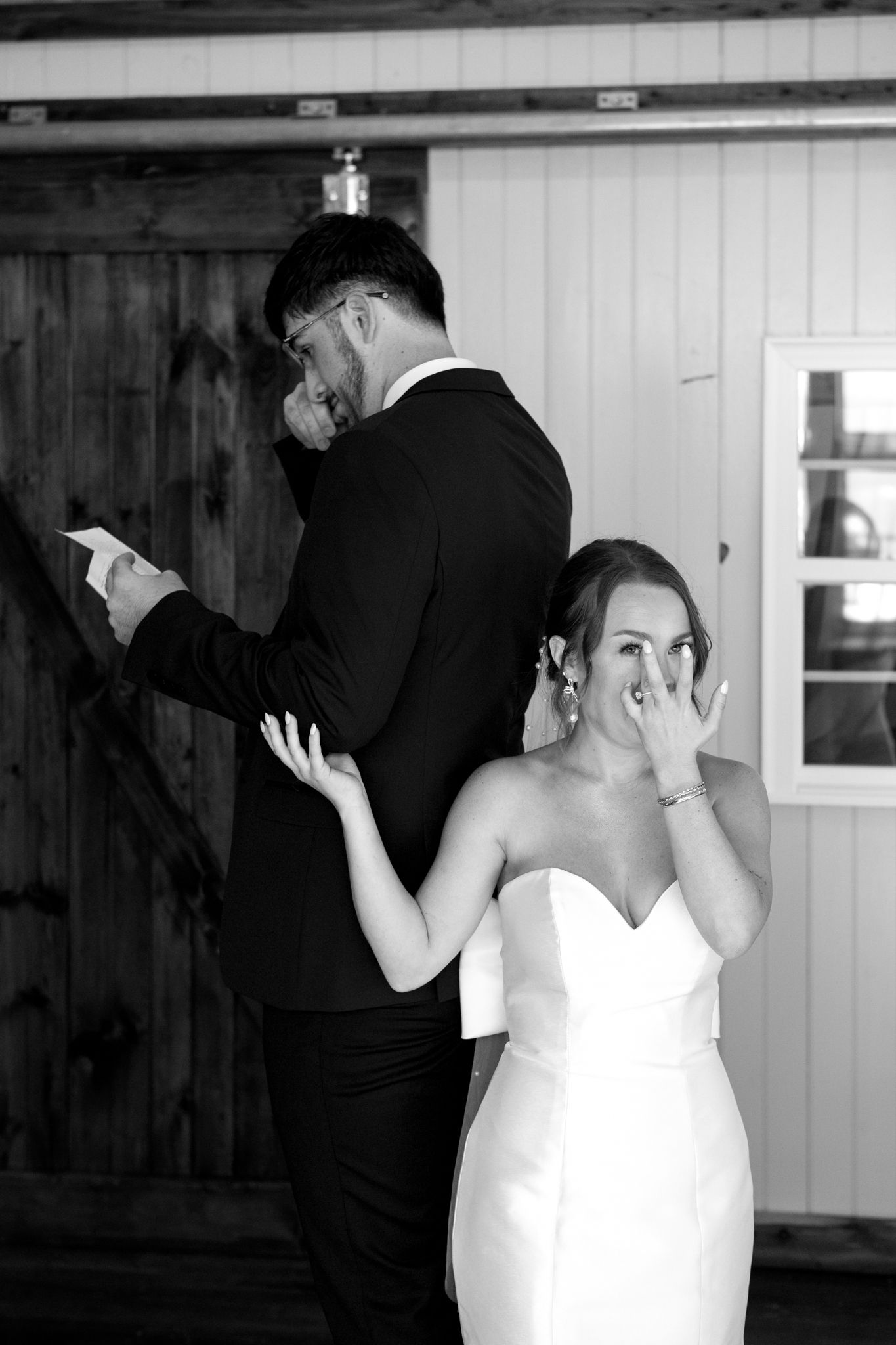 black and white photo of couple filled with joyful tears sharing vows