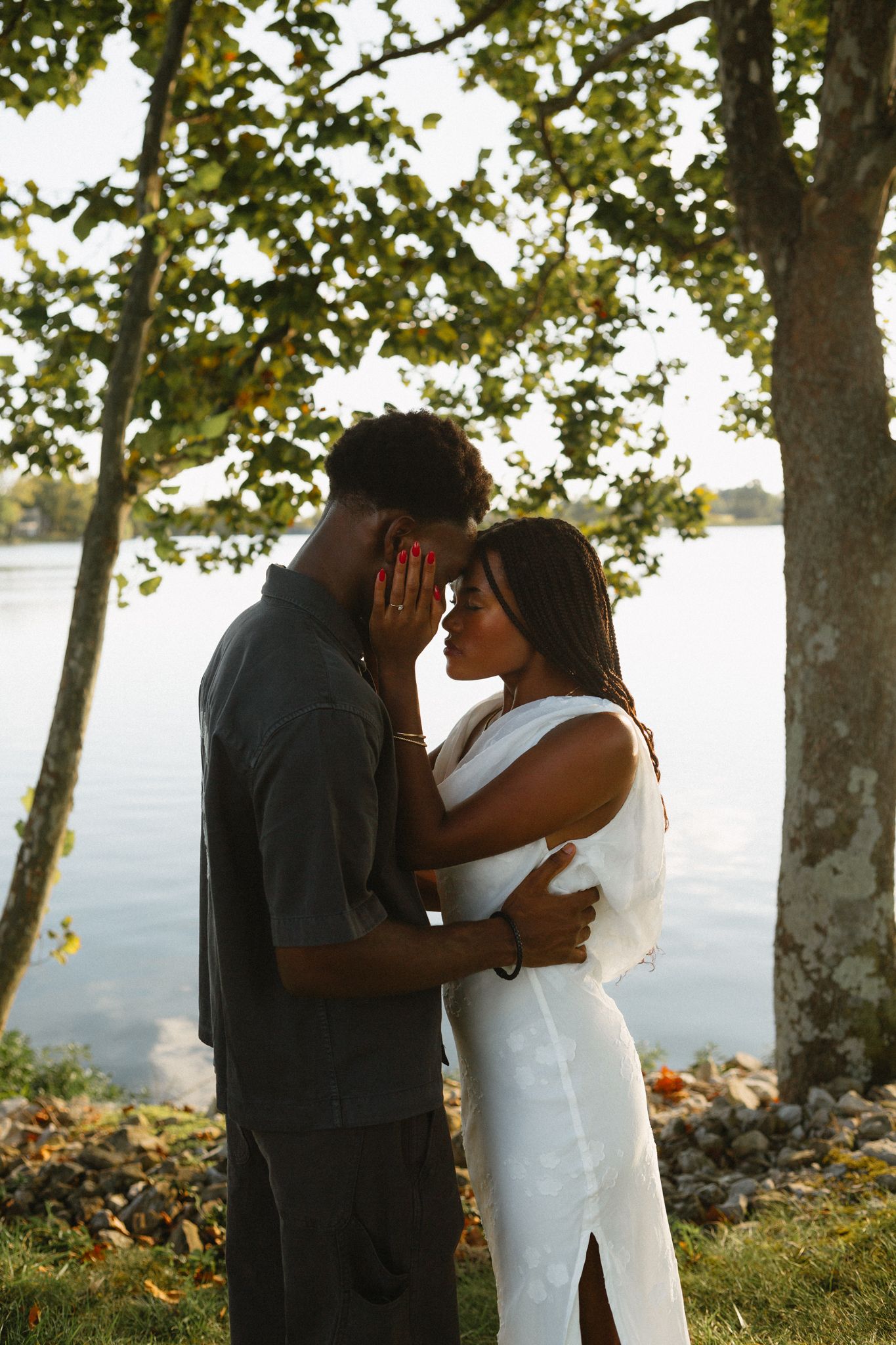 Romantic proposal at a lakeside location in Lexington, Kentucky, with a young Black couple.