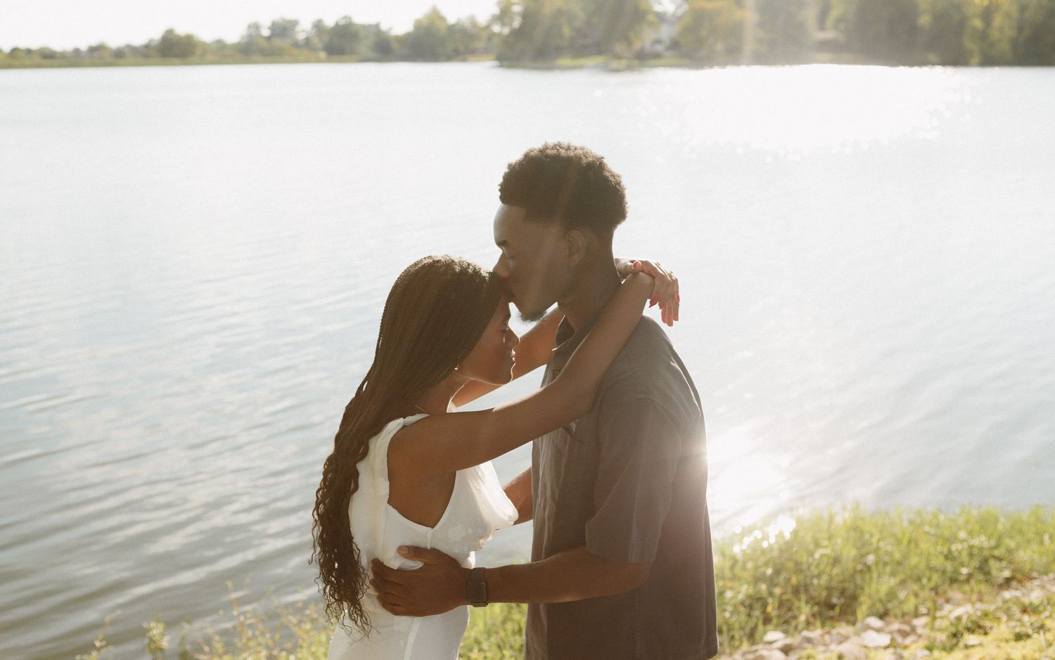 Romantic proposal at a lakeside location in Lexington, Kentucky, with a young Black couple.
