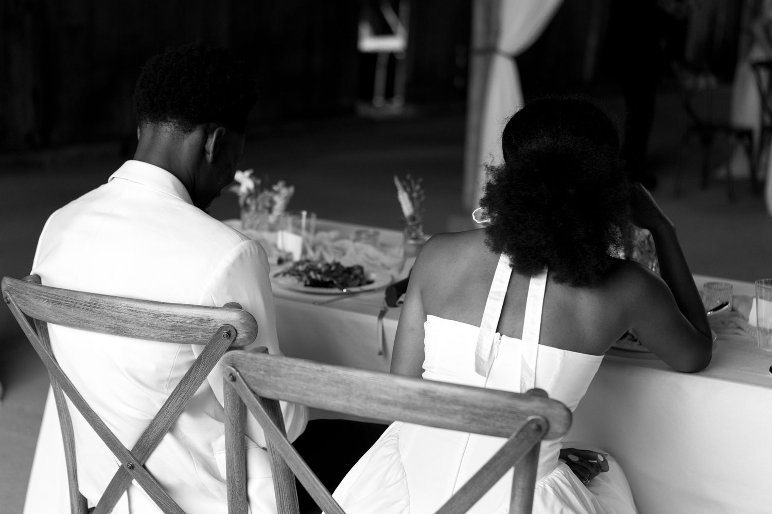 Black and white candid shots of emotional moments during a wedding reception.