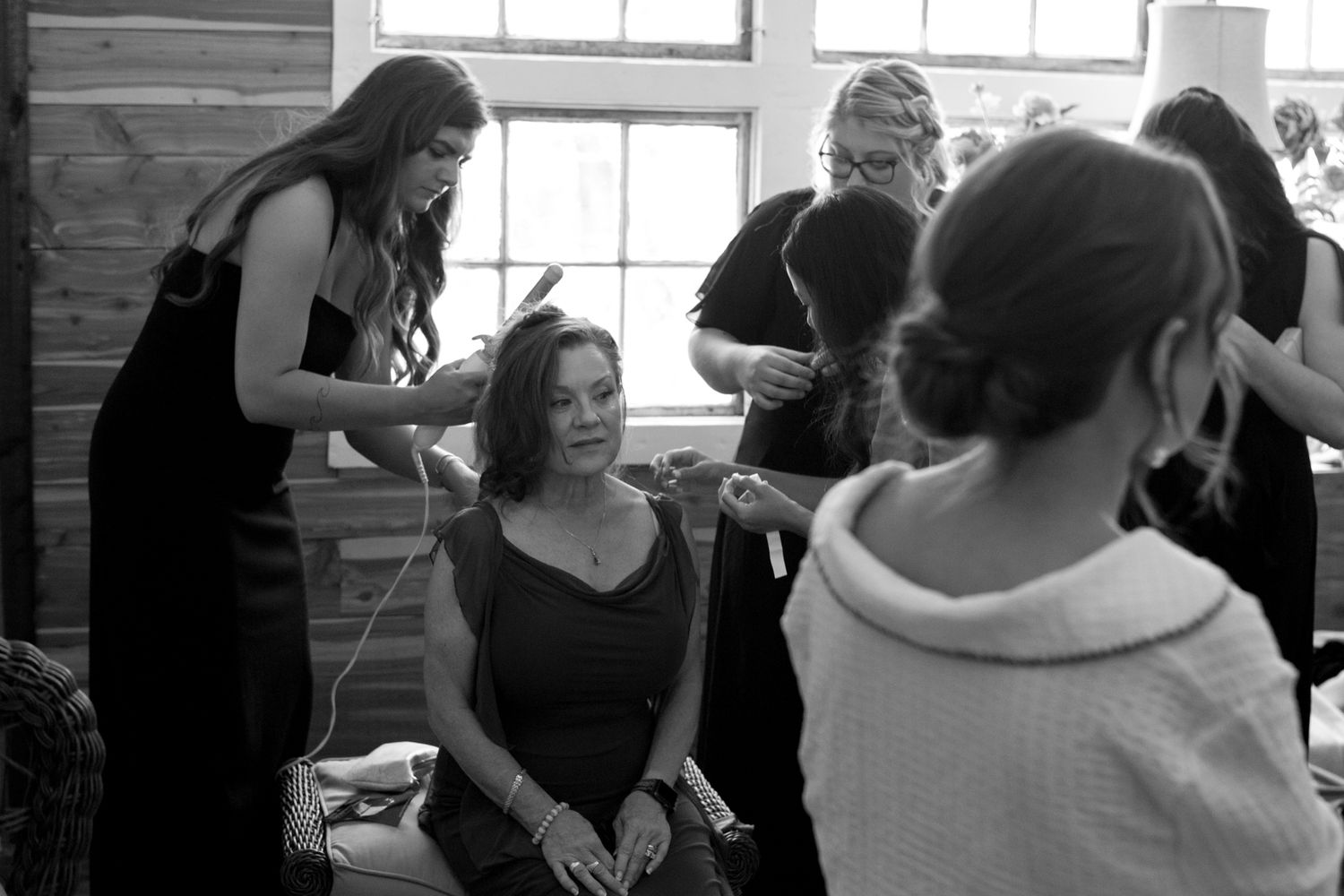 Bridesmaids joyfully preparing for the wedding, surrounded by elegant dresses and excited chatter in a bright, cheerful