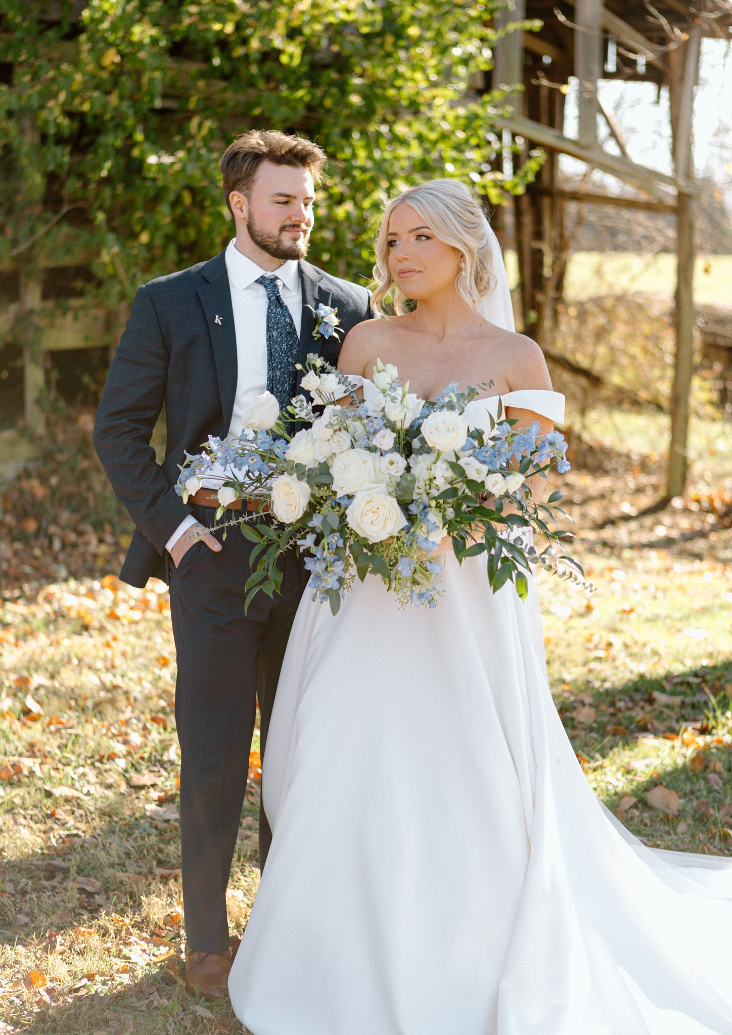 Bride and groom posing with a lush bouquet at Silo Farms. Photo by Joia Lyn, KY wedding photographer