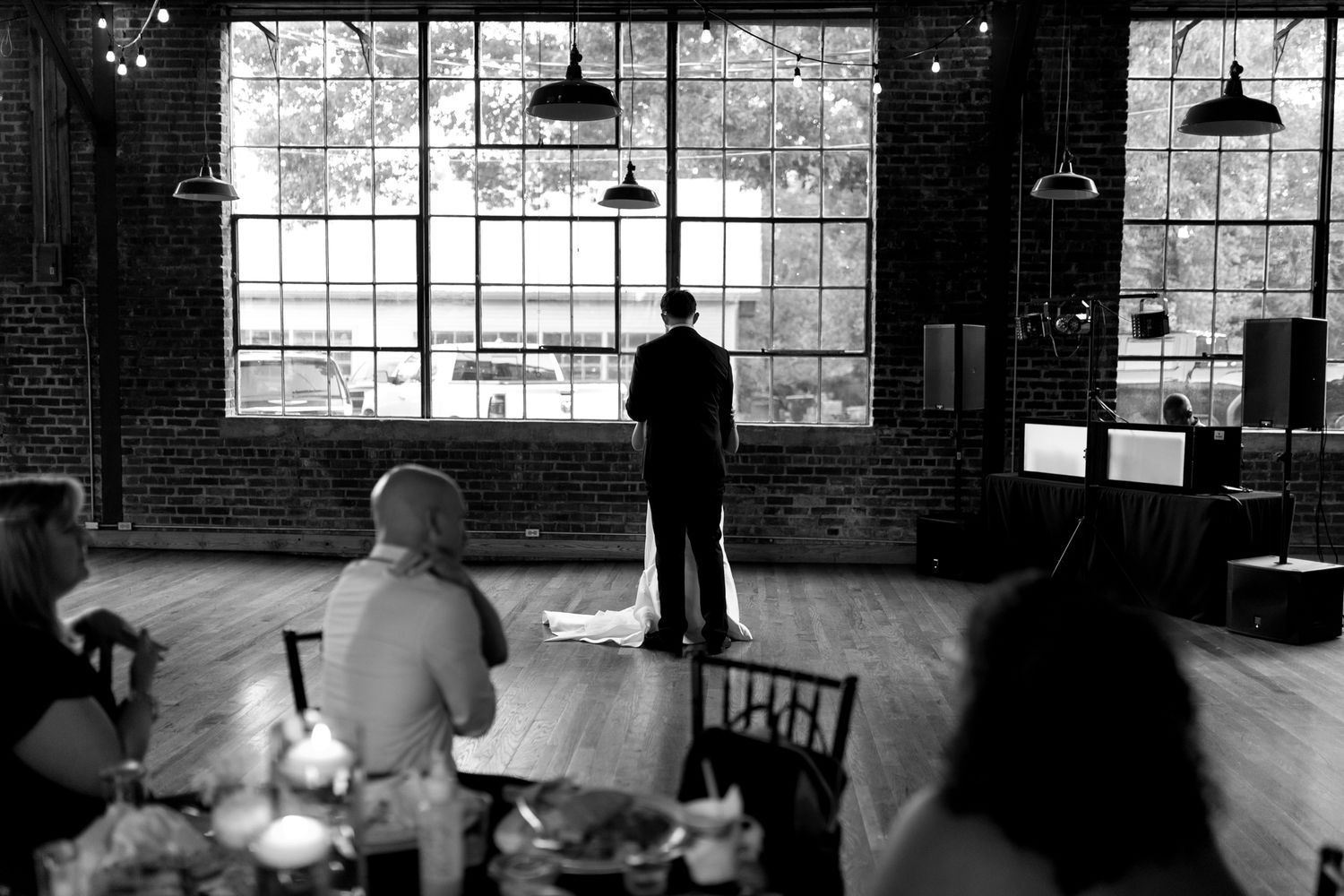 black and white photo Bride and groom sharing a romantic first dance at an outdoor reception