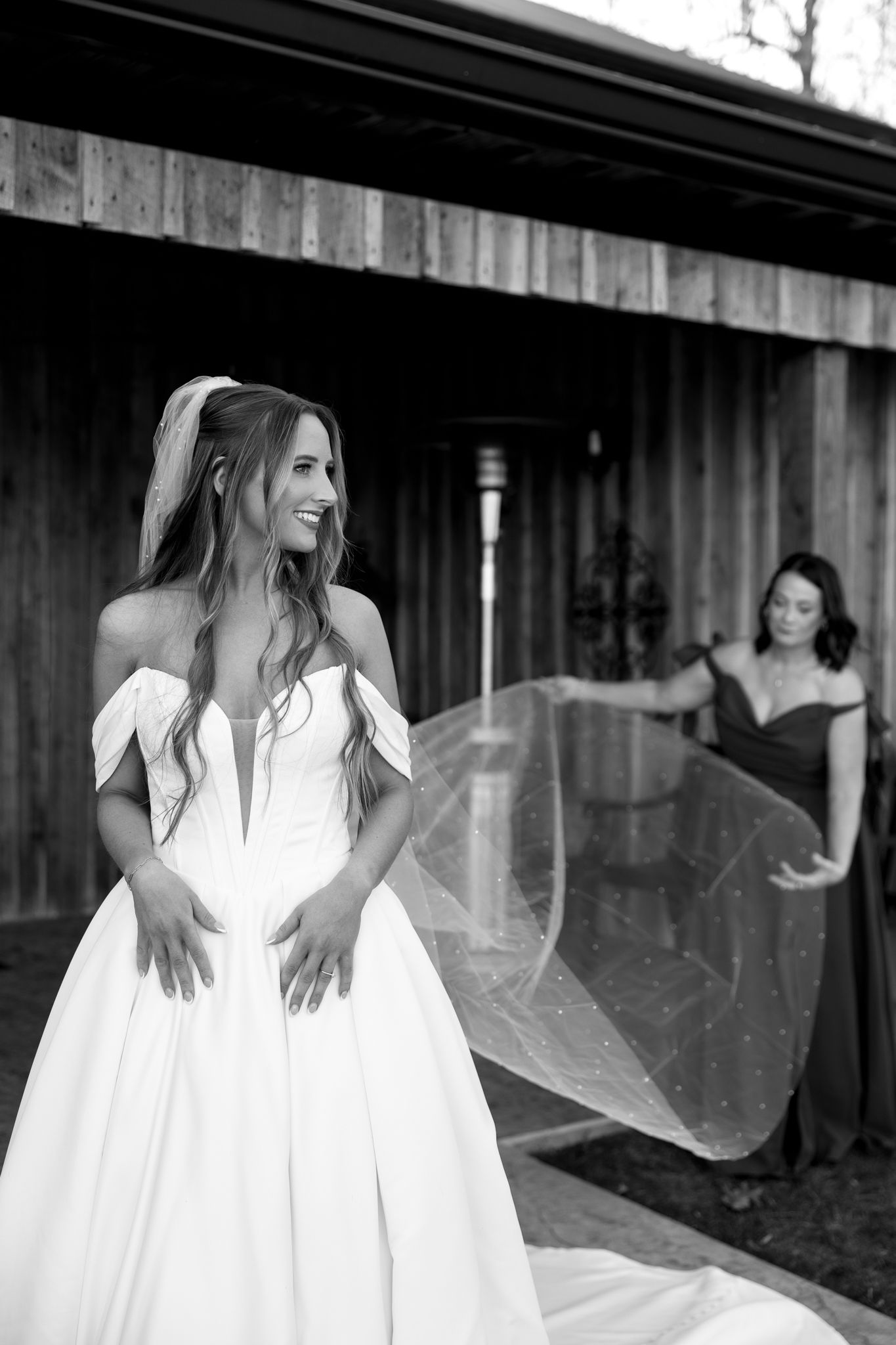 Artistic black and white series showing flowing white wedding dress with veil in motion.