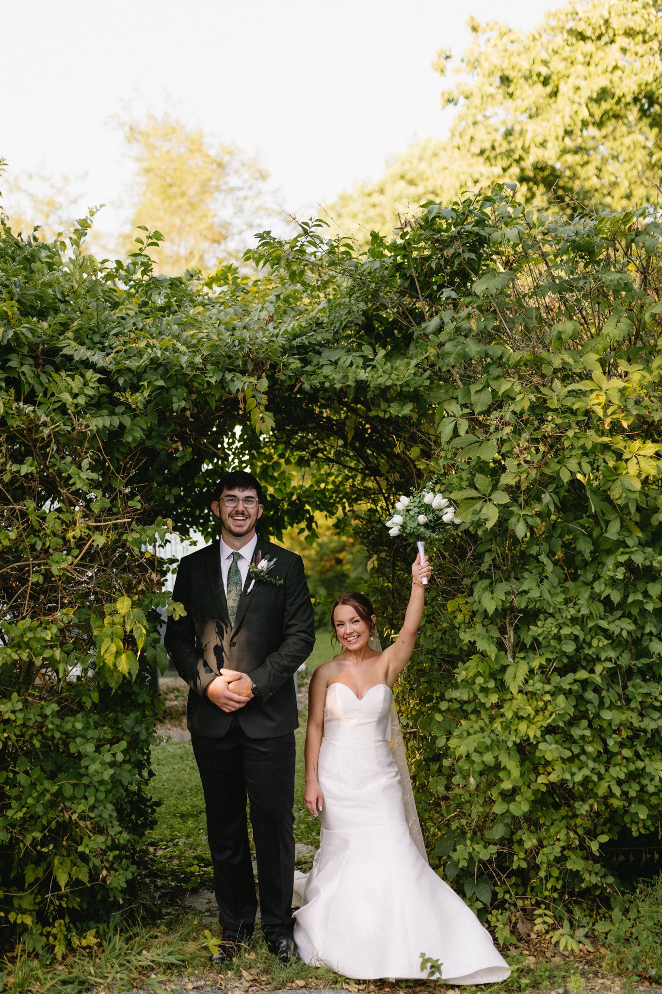 Romantic outdoor wedding photo of the bride and groom in a grassy field