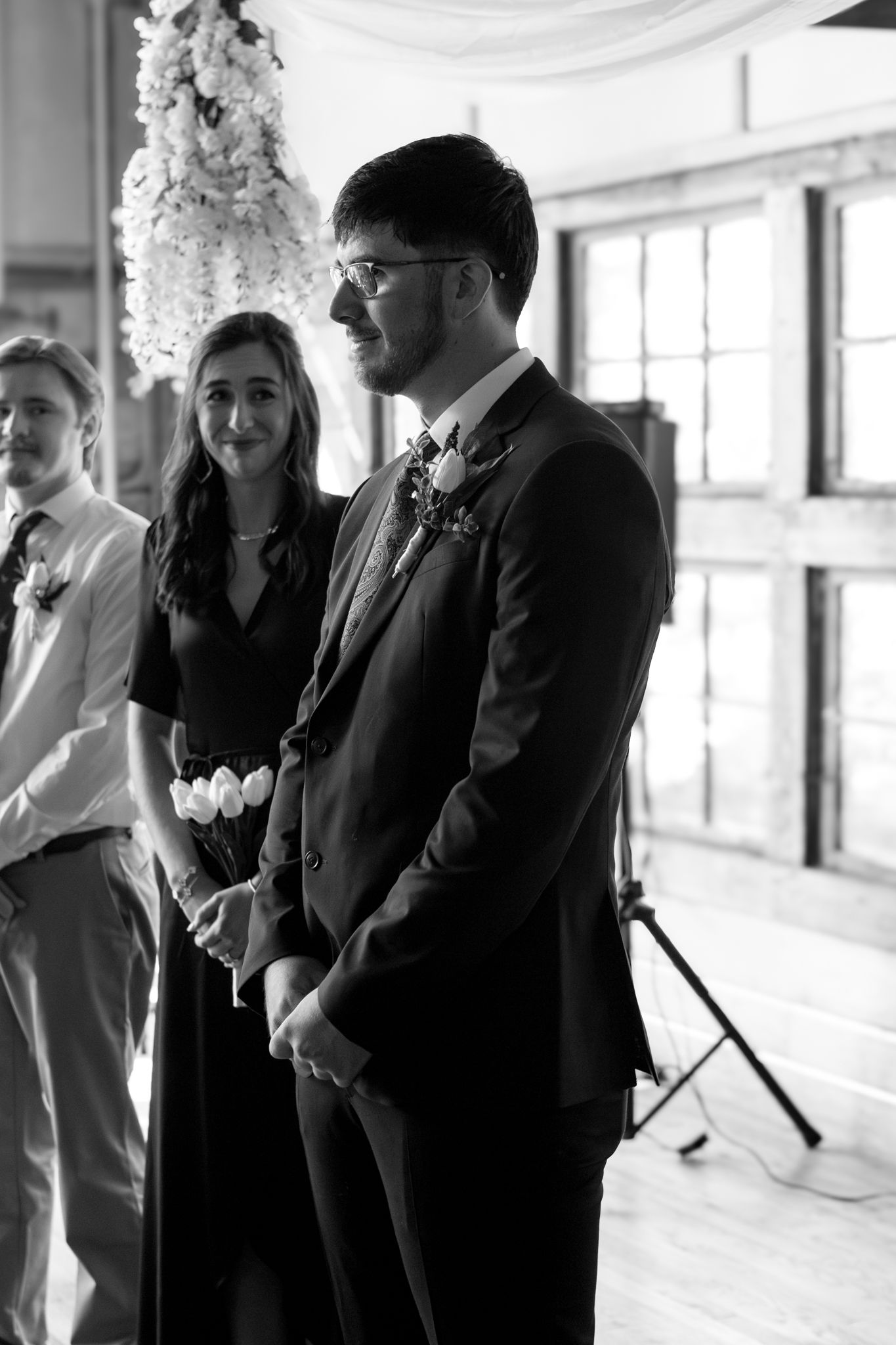 groom waiting next to groomsmen, patiently waiting to see the bride