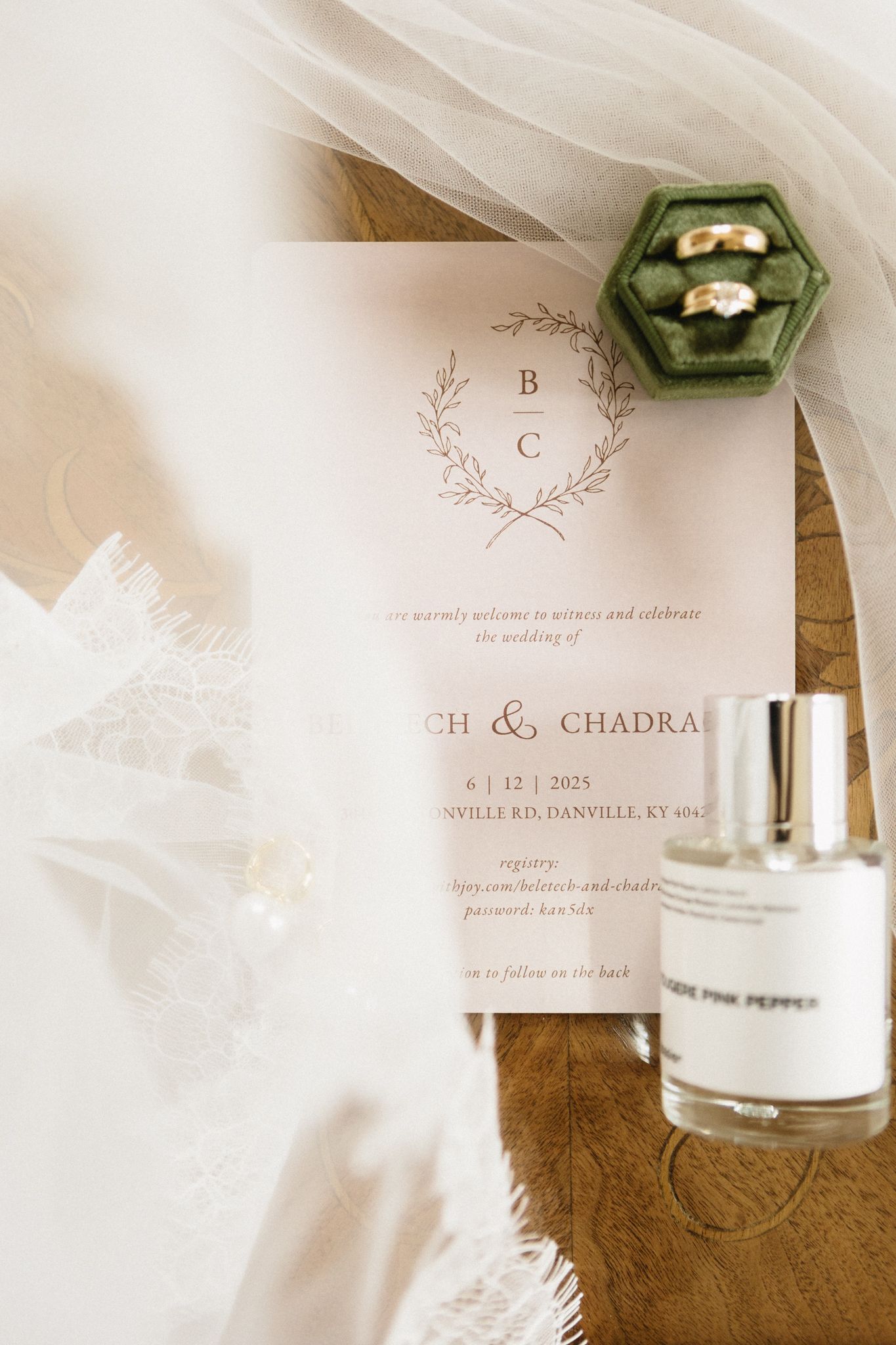 Wedding invitation details with elegant typography and monogram design on soft white paper with decorative elements.