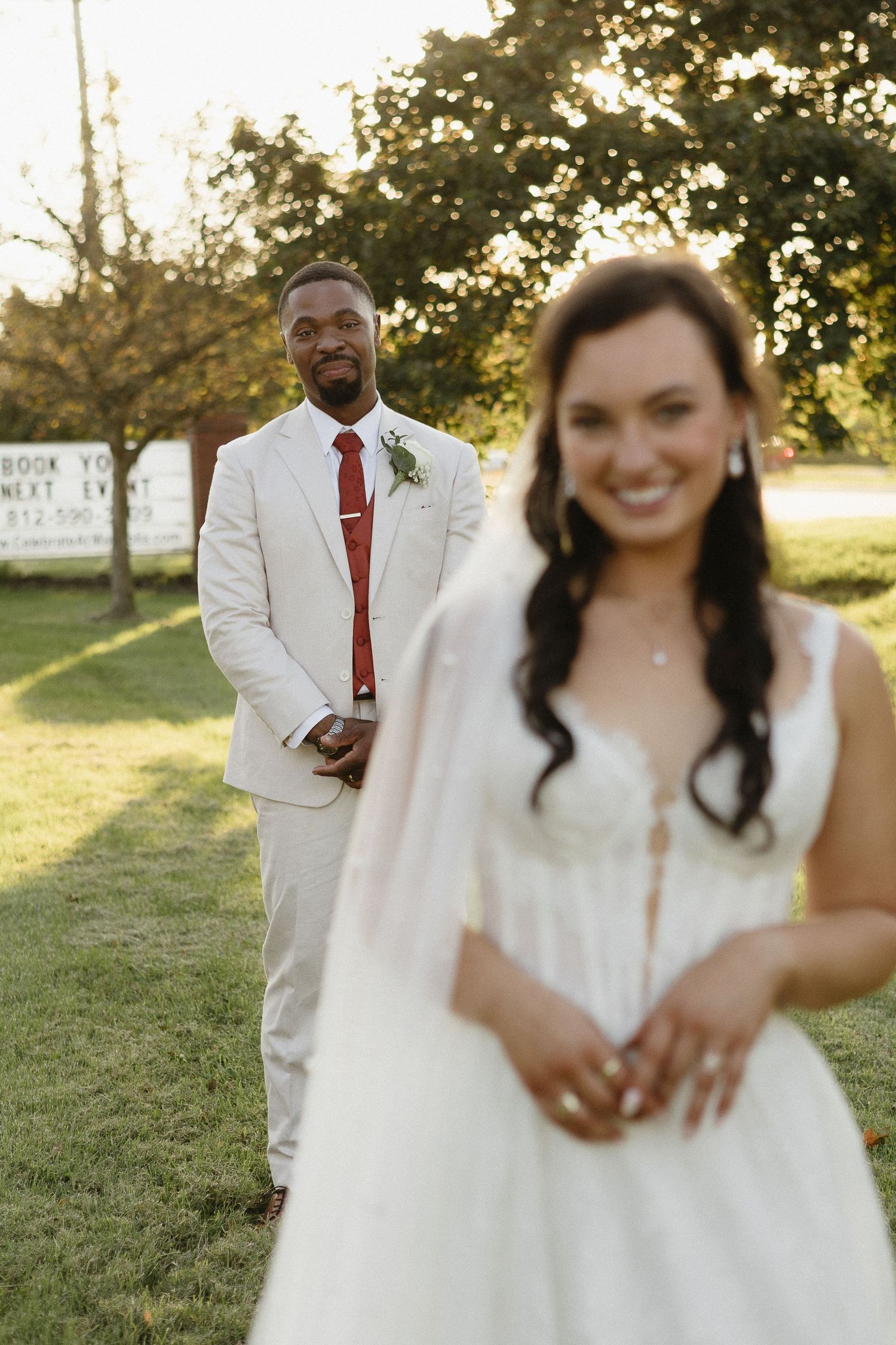 Candid wedding couple portraits in natural sunlit outdoor setting.