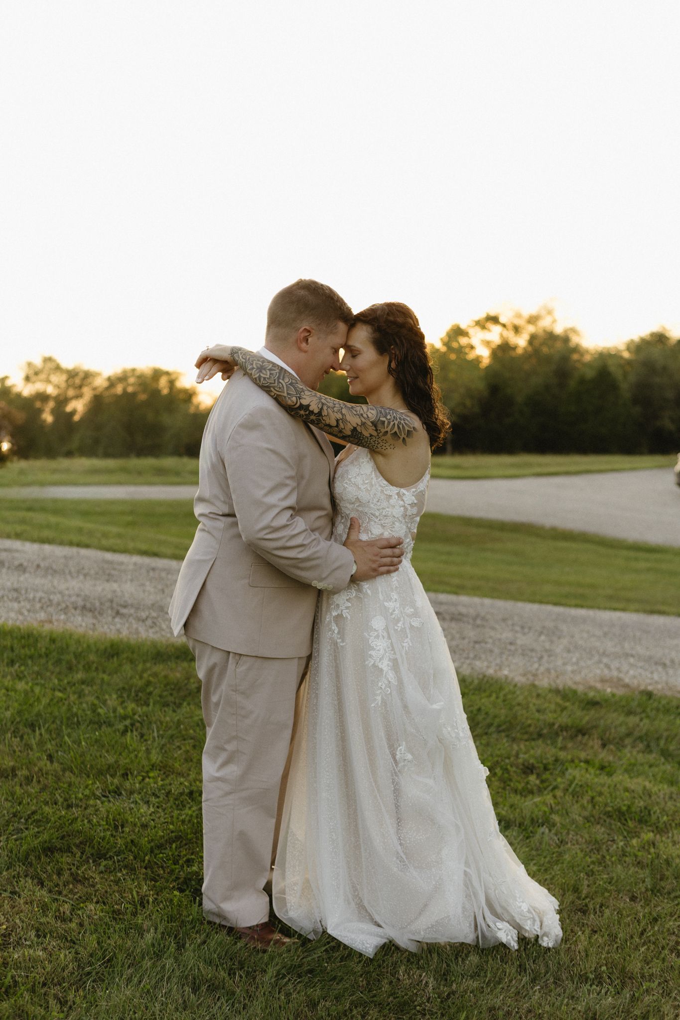 A romantic sunset moment captured in a grassy field during golden hour.