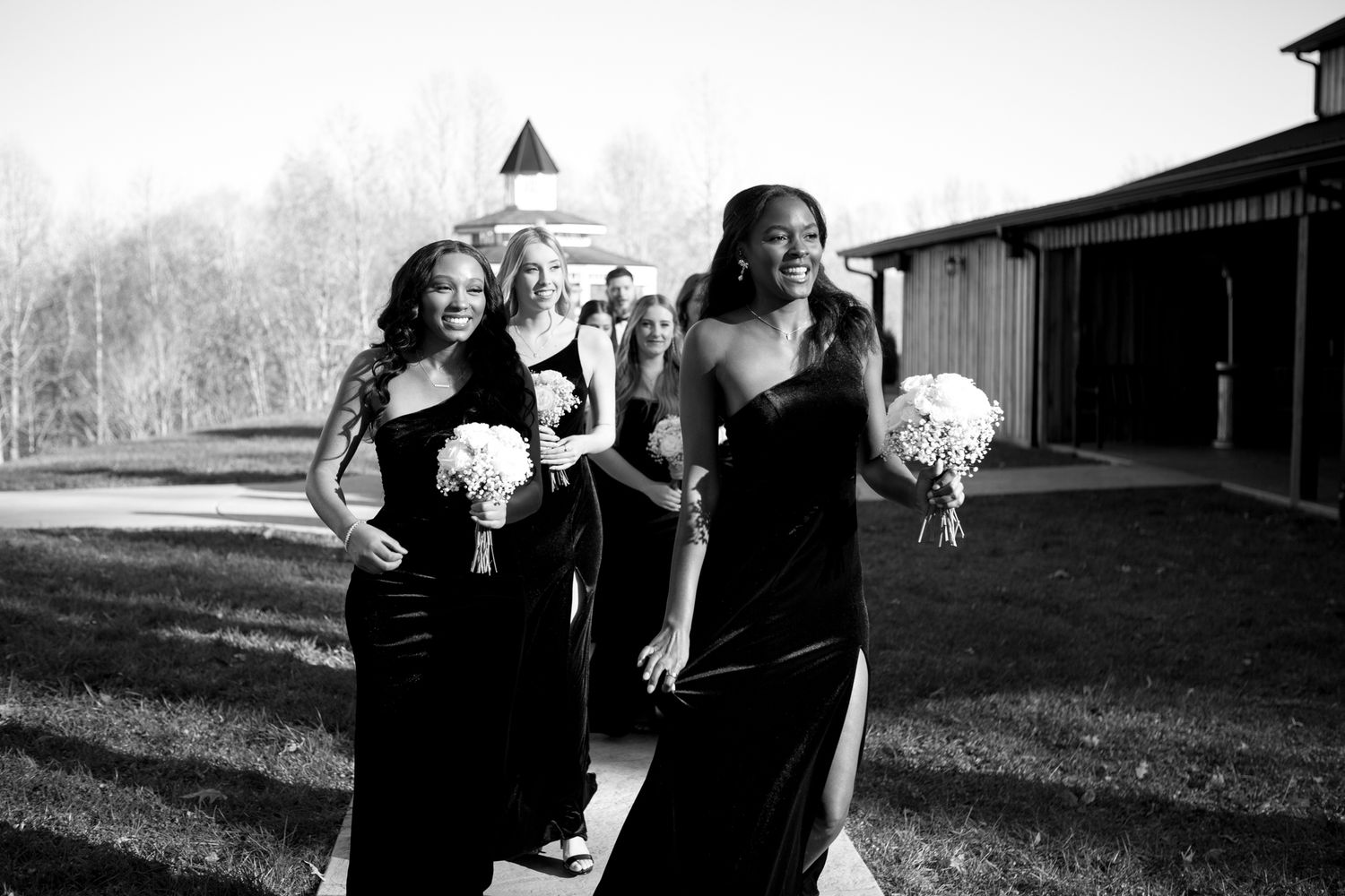Candid outdoor wedding moments captured in black and white.
