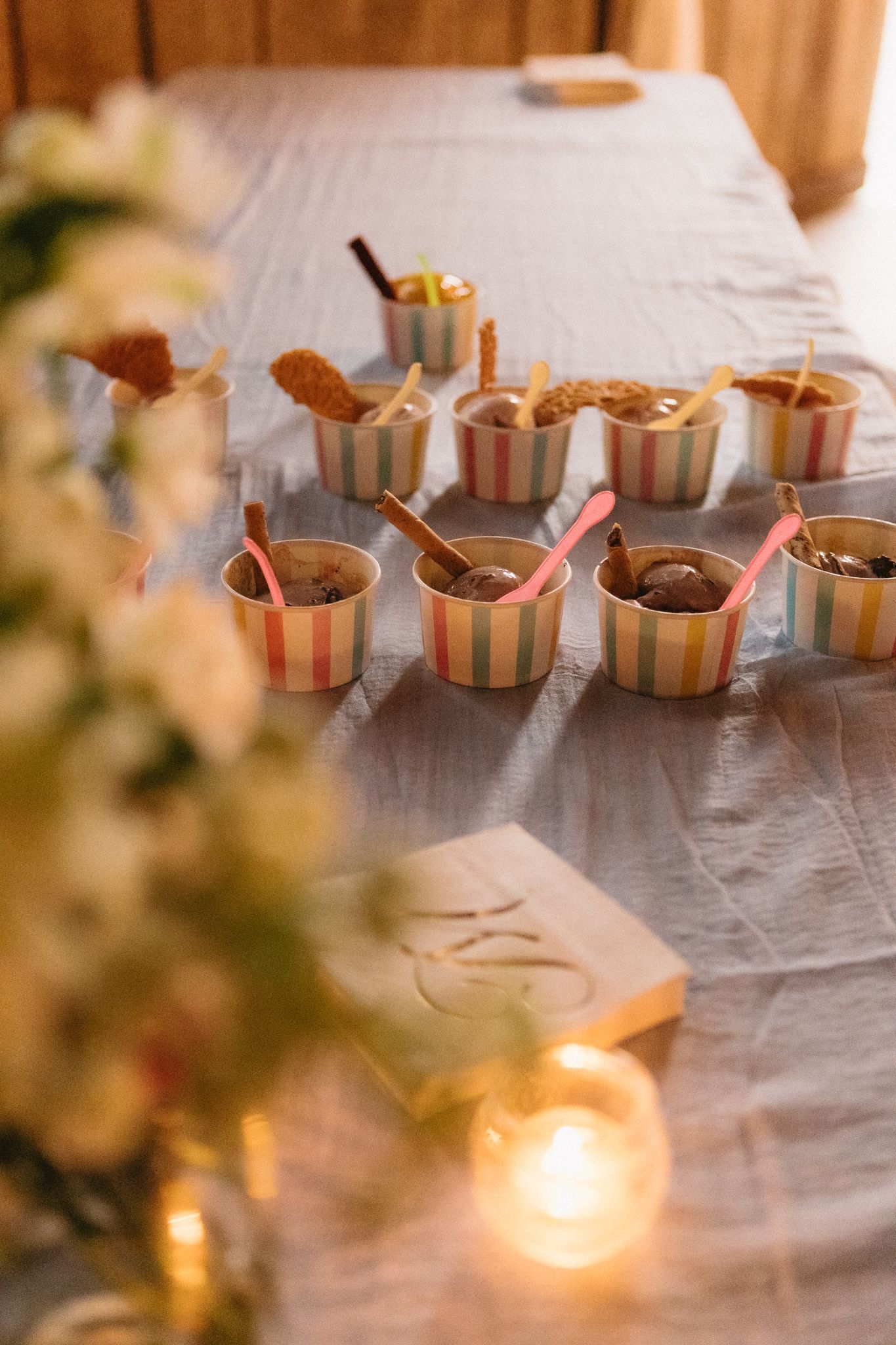 Wedding reception table detail with elegant candlelit favors and decorative settings.