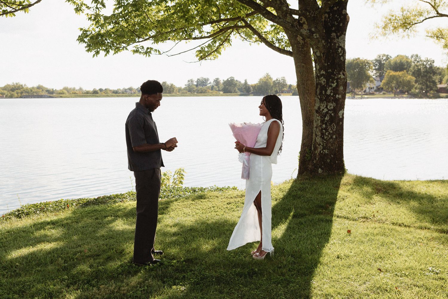 Chadrack proposing to Belle with a bouquet of flowers at their favorite Bible study spot in Lexington.