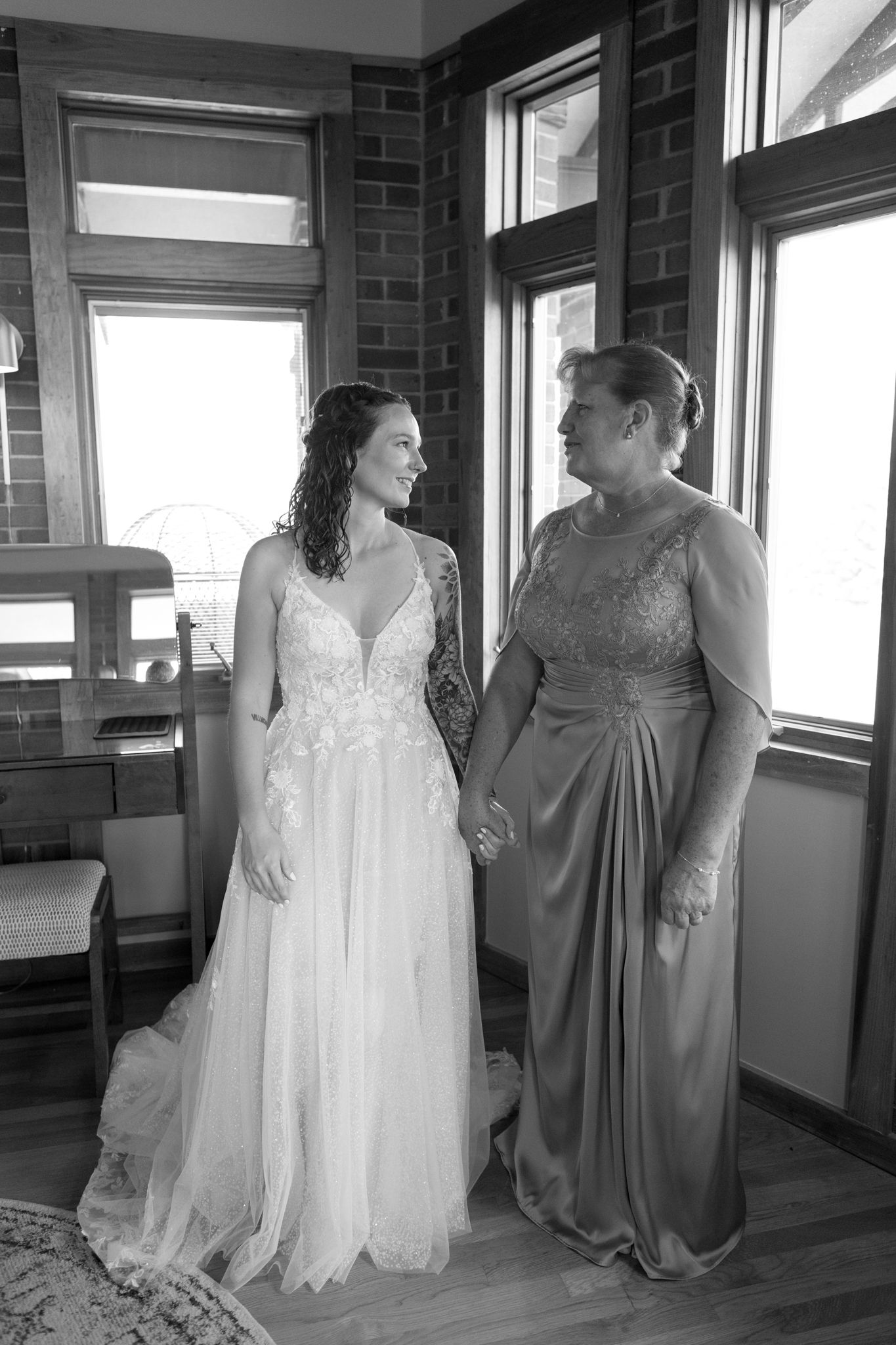 Black and white photo series showing a tender moment between two people in formal attire in an indoor setting.