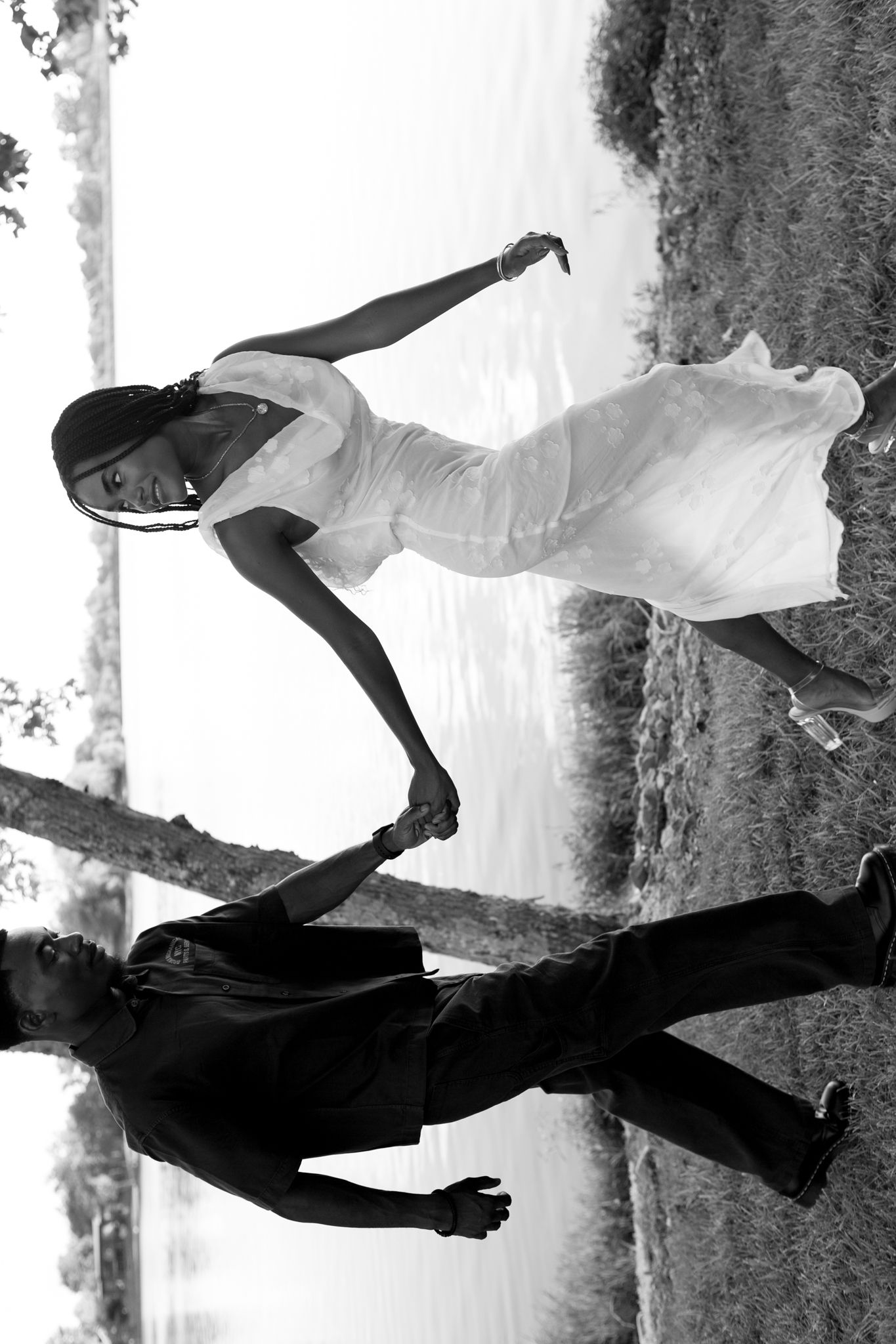 Newly engaged couple, Belle and Chadrack, holding hands and smiling during their proposal photoshoot in Kentucky.