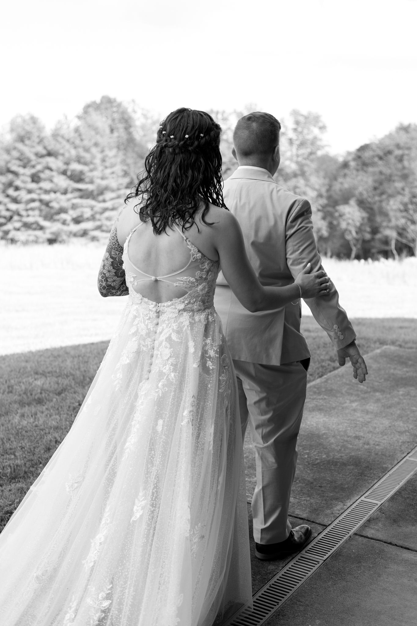 A romantic black and white photo series showing a couple dancing together at their wedding celebration.