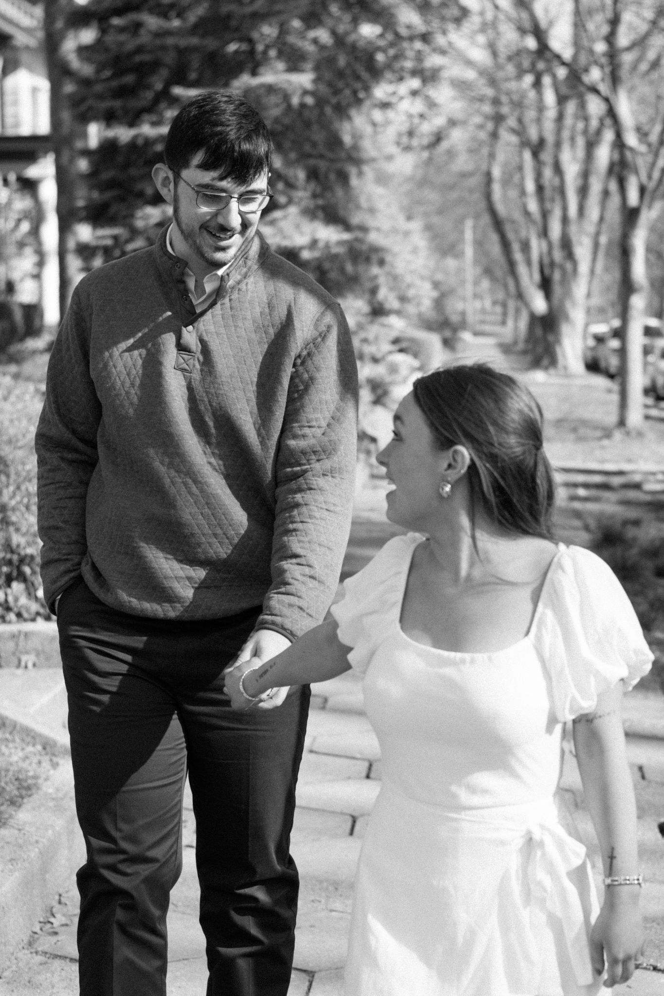 Romantic engagement photo of couple holding hands in Old Louisville's picturesque streets on a cold day