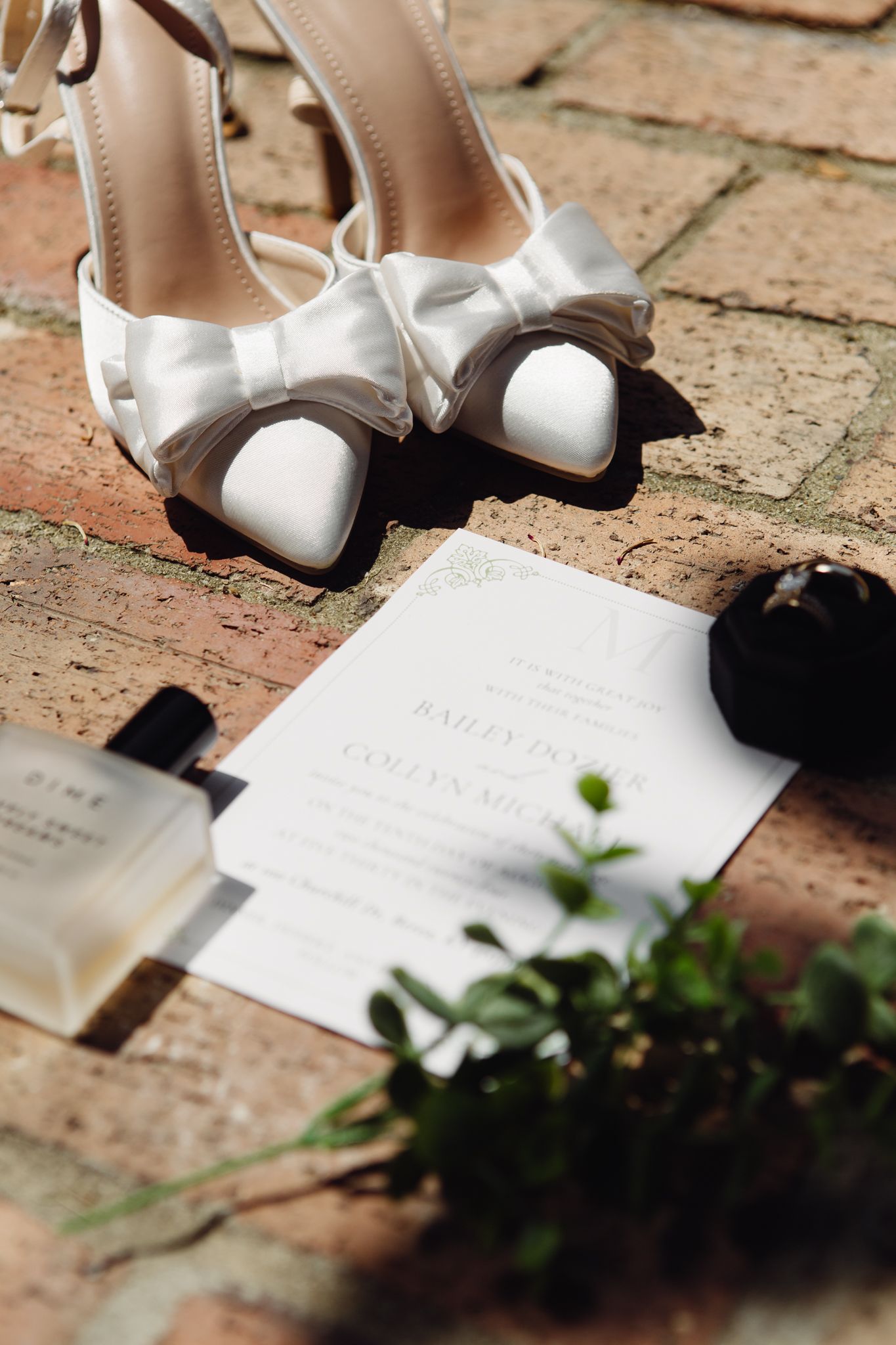 An artistic arrangement of a wedding invitation, fashionable shoes, and a radiant wedding ring, capturing the essence