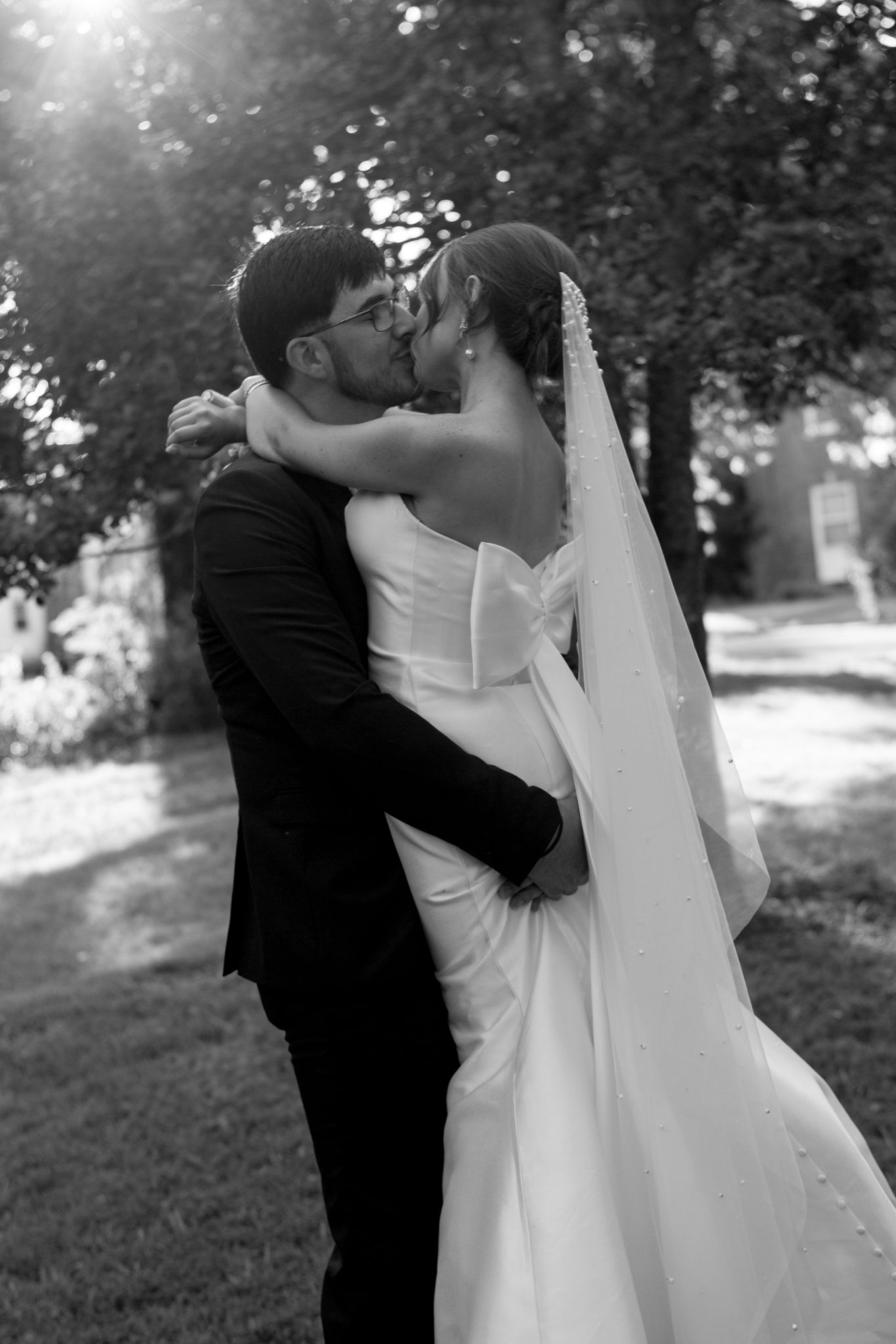 Romantic outdoor wedding photo of the bride and groom in a grassy field