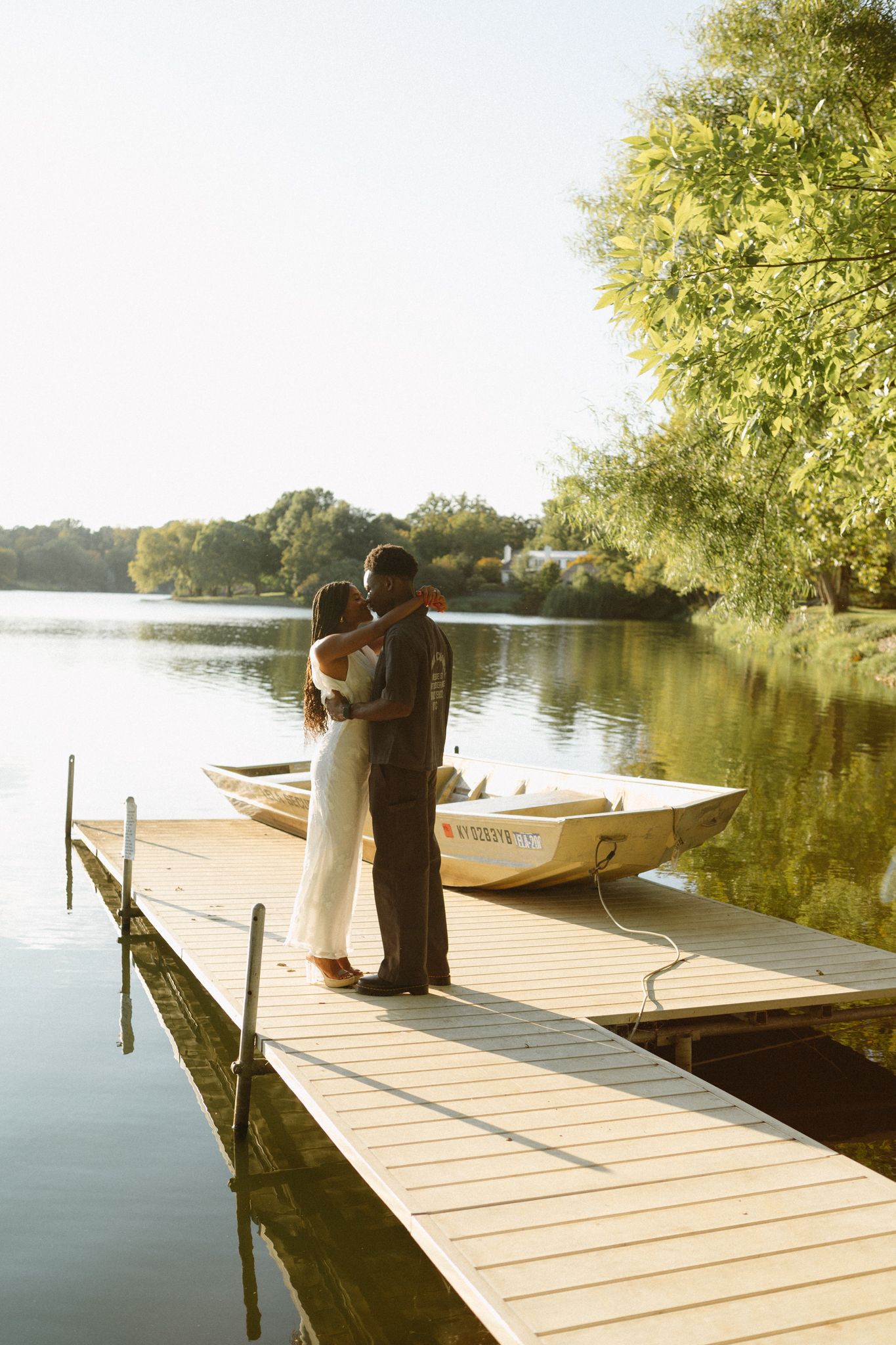 Romantic proposal at a lakeside location in Lexington, Kentucky, with a young Black couple.