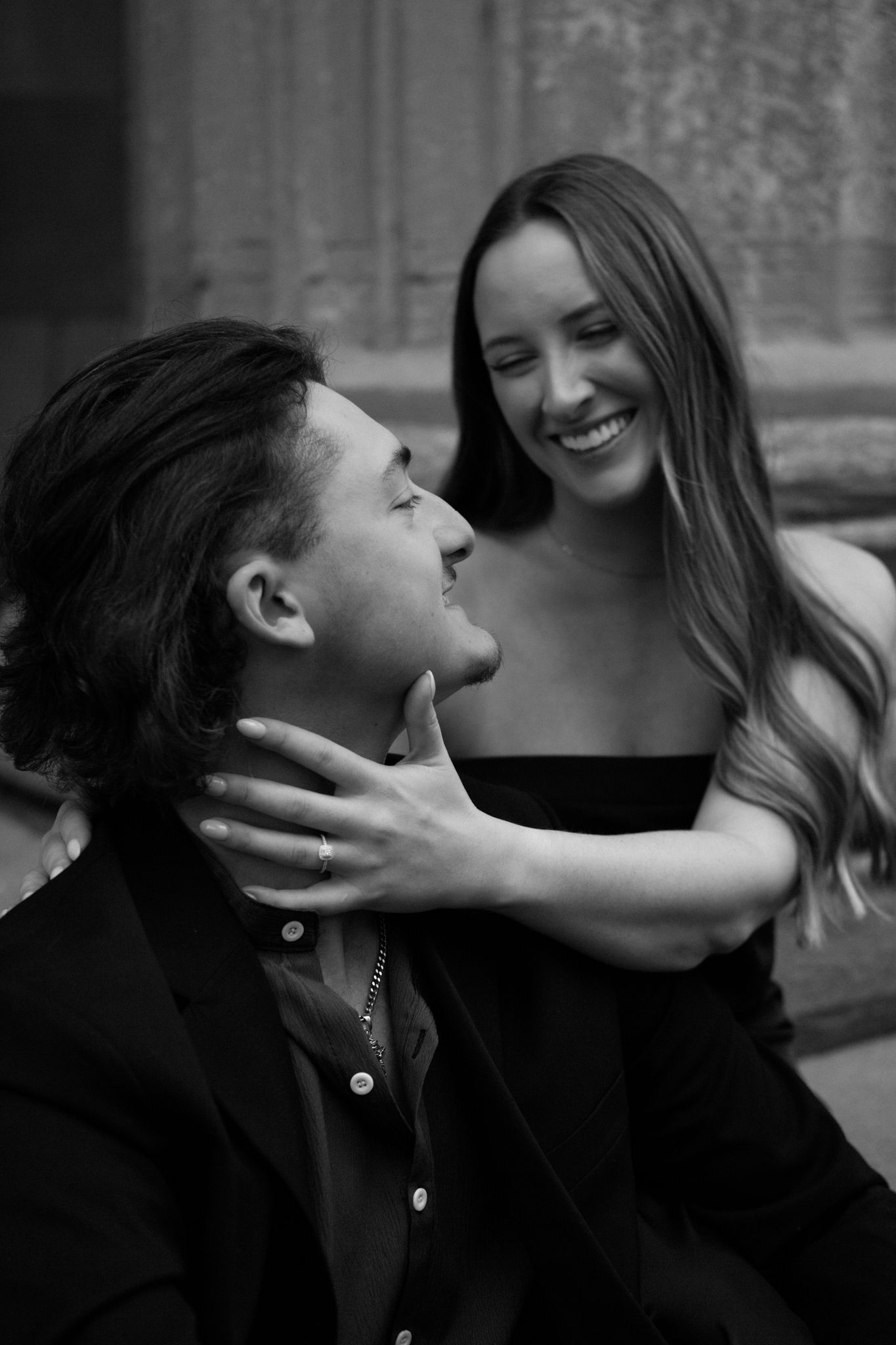 photo of an engaged couple embracing, sharing an intimate moment in downtown Louisville