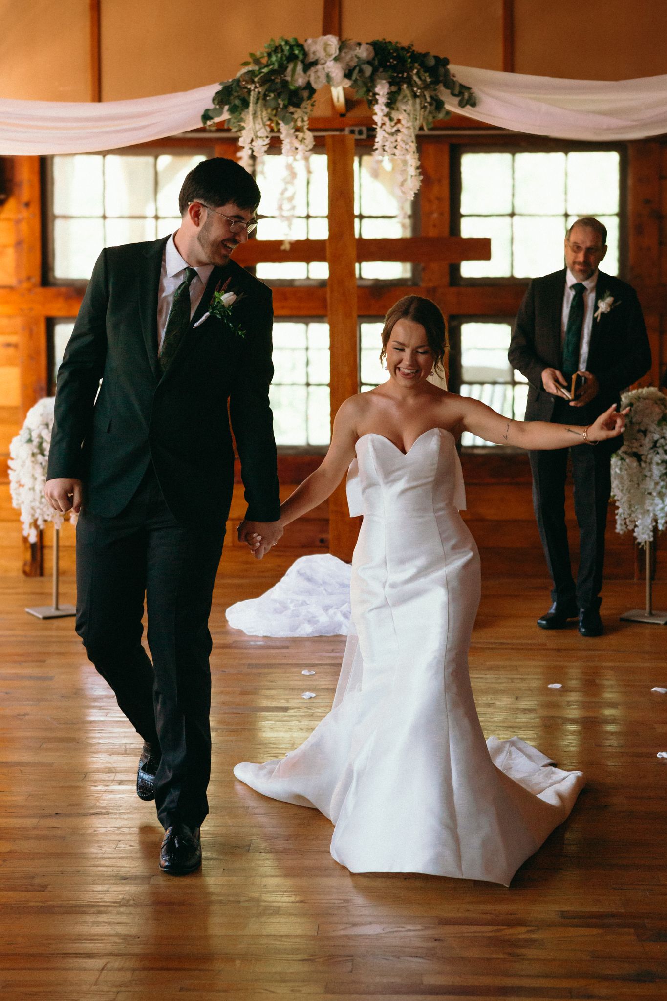 bride and groom walk down the aisle happy after getting married