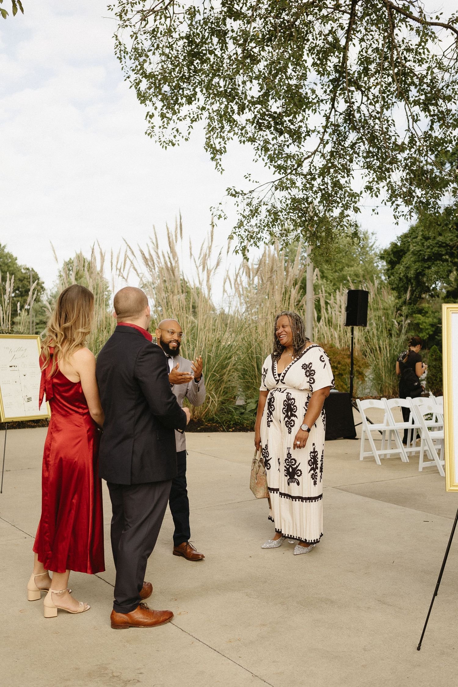 Wedding guests dance together on an outdoor patio during a celebration event.