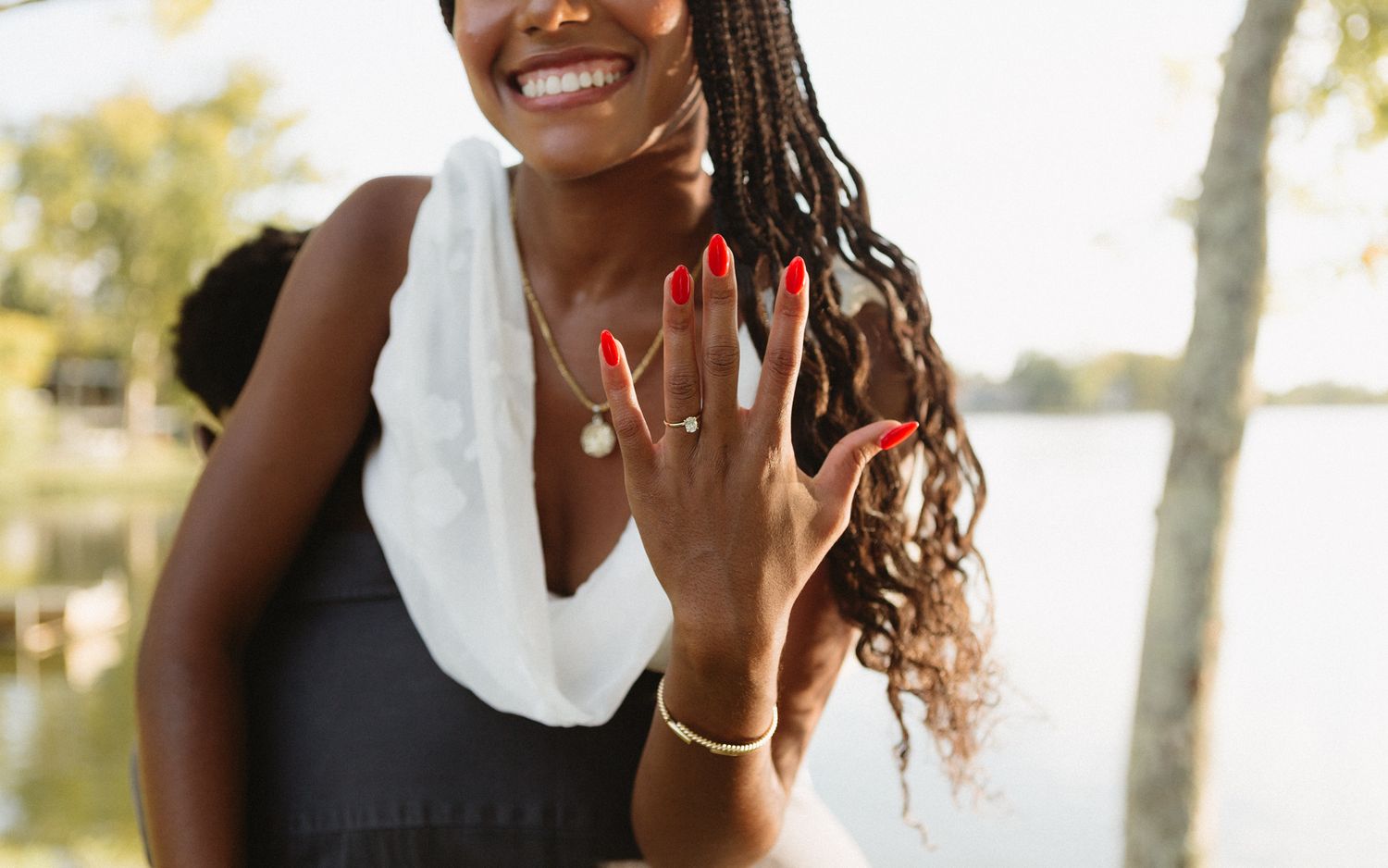 Romantic proposal at a lakeside location in Lexington, Kentucky, with a young Black couple.