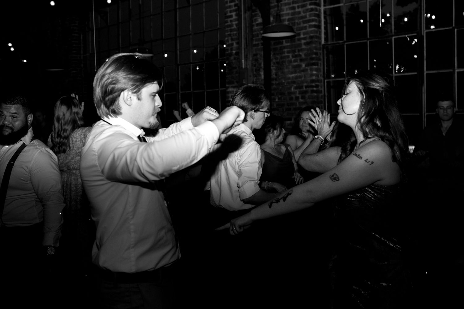 Fun-filled wedding reception with guests dancing to live music.