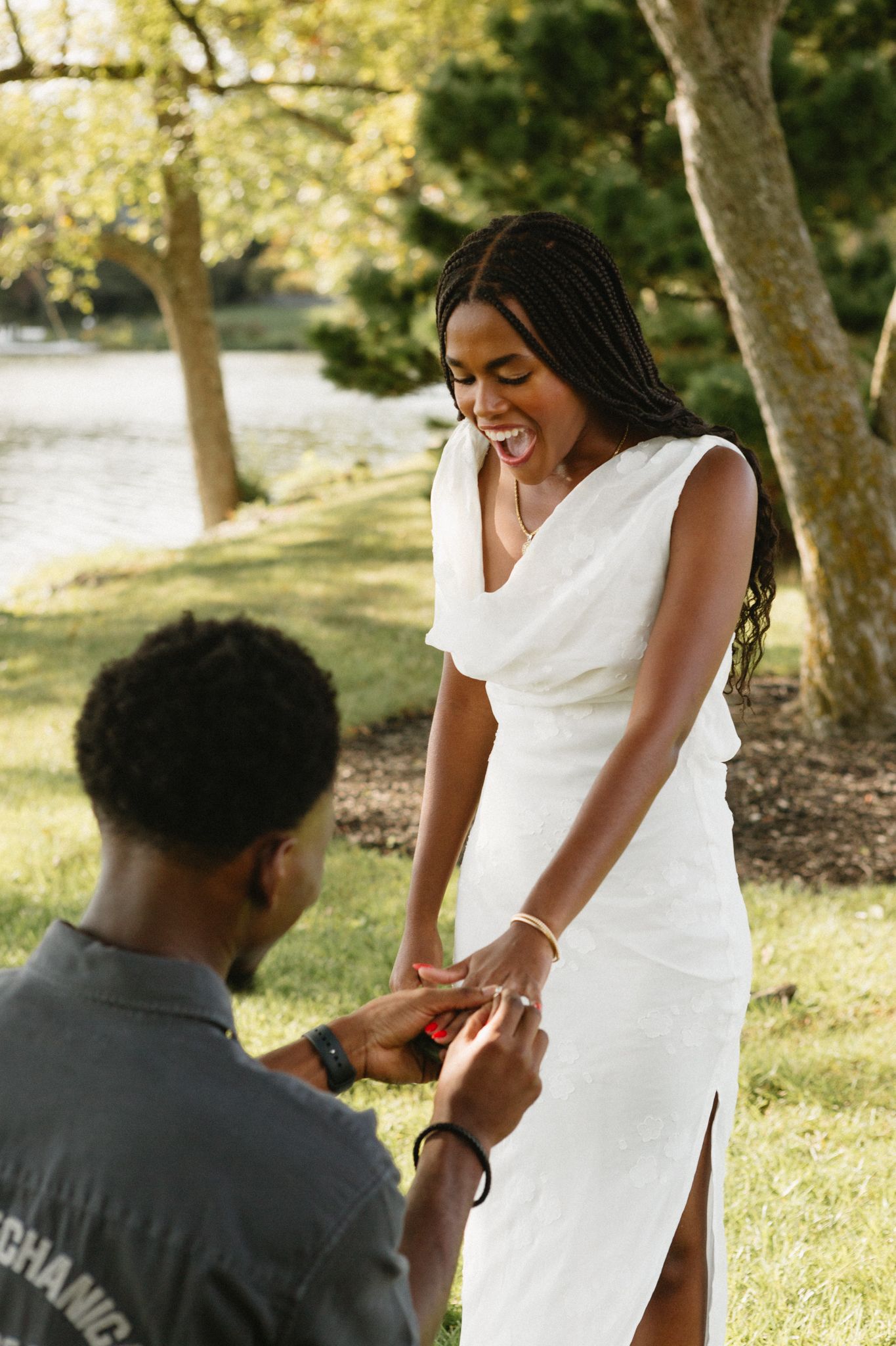 Joyful moment as Belle says yes to Chadrack's proposal by a peaceful lake in Kentucky.