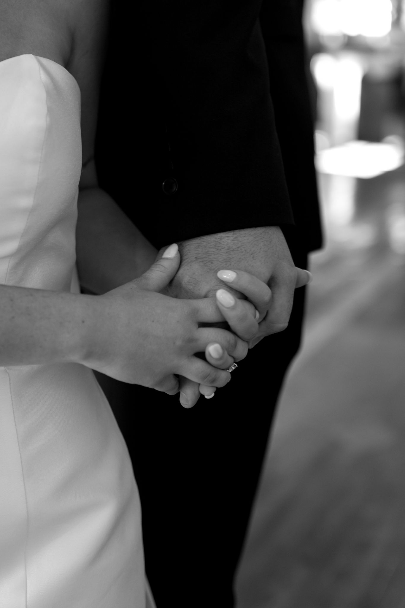 couple holding hands before wedding ceremony black and white photo
