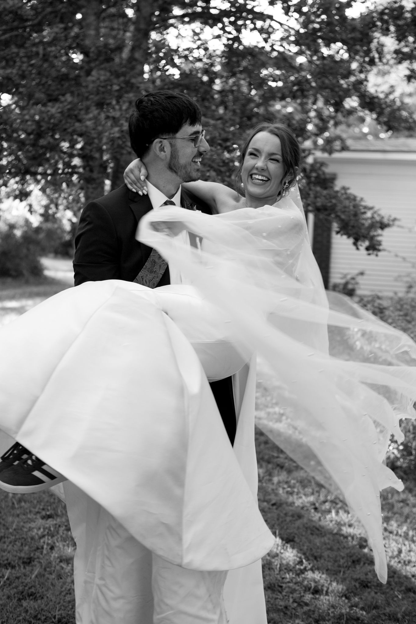 Romantic outdoor wedding photo of the bride and groom in a grassy field
