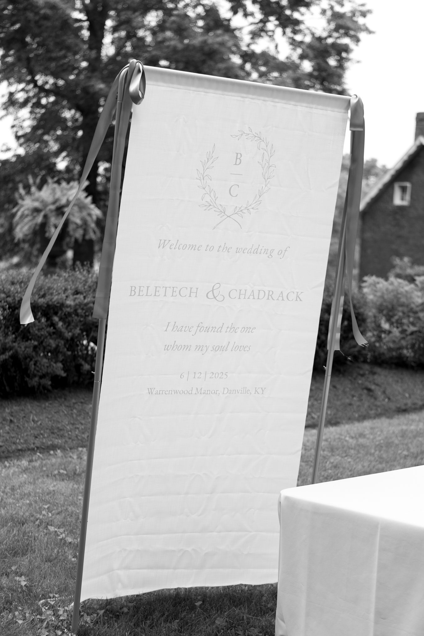 A series of elegant white wedding signage displays shown outdoors against a natural background.