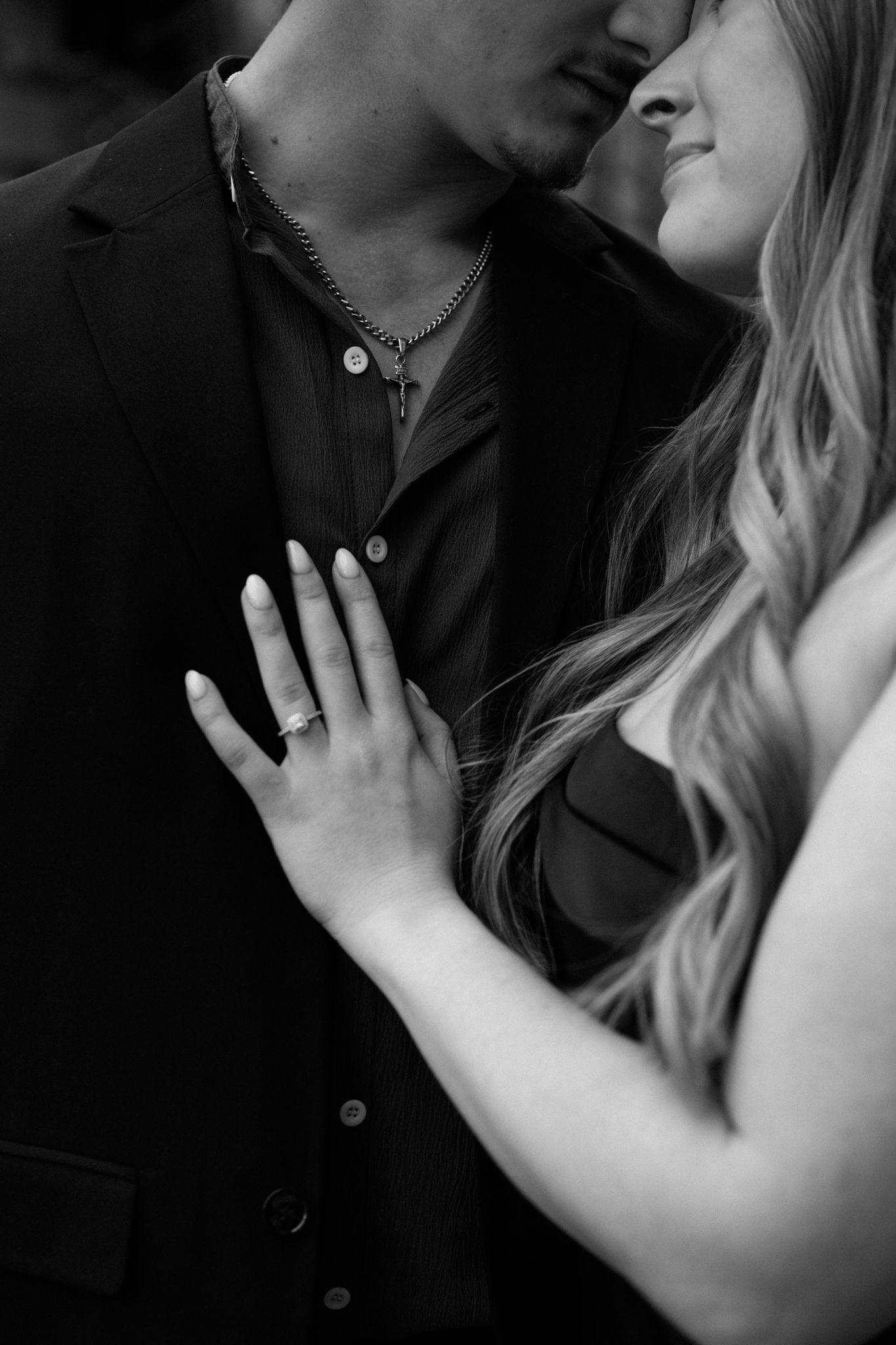 photo of an engaged couple embracing, sharing an intimate moment in downtown Louisville