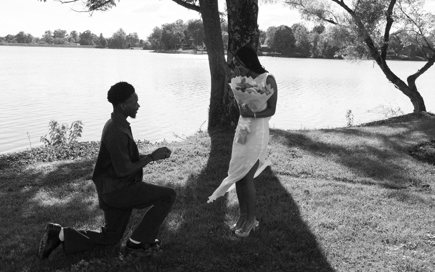 Joyful moment as Belle says yes to Chadrack's proposal by a peaceful lake in Kentucky.