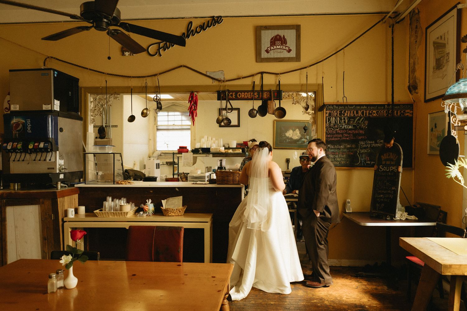 A panoramic view of an empty reception venue with wooden floors and ambient lighting.