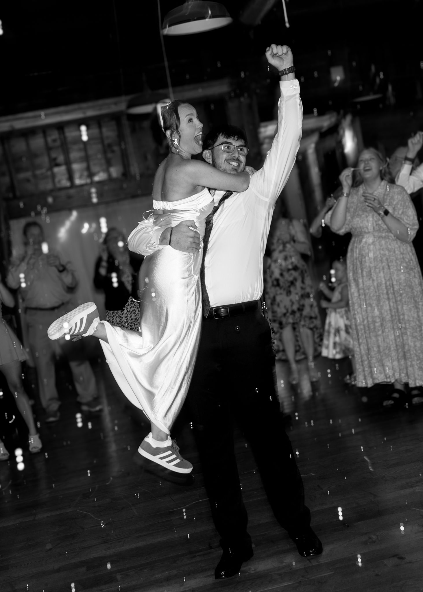 Happy couple surrounded by friends and family on the dance floor
