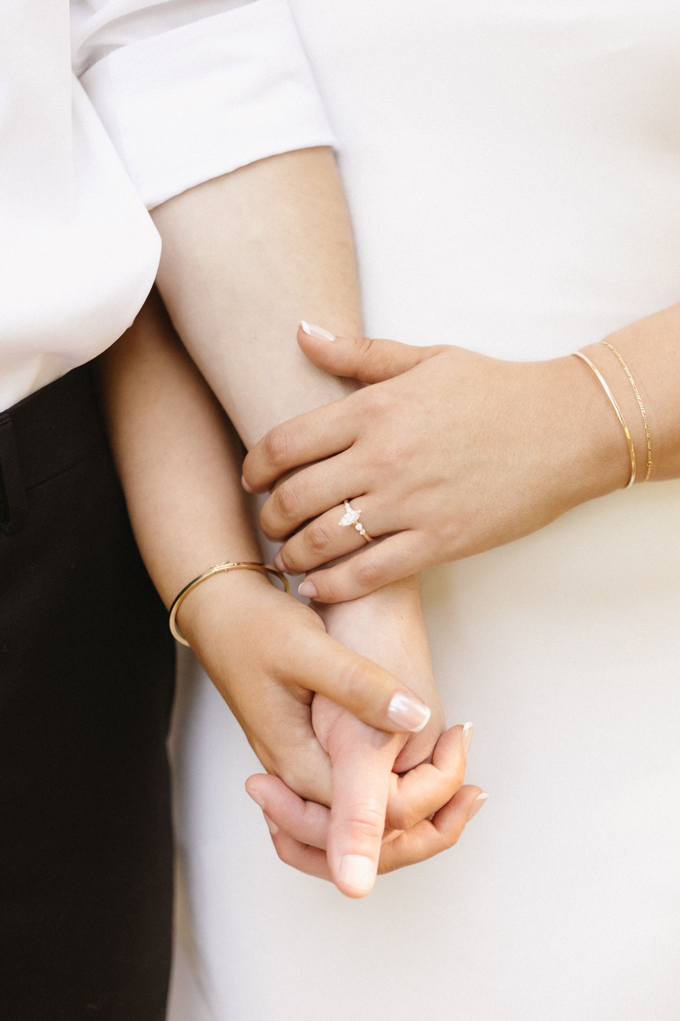 A series of minimalist photos showing hands wearing delicate gold rings and bracelets against a white background.