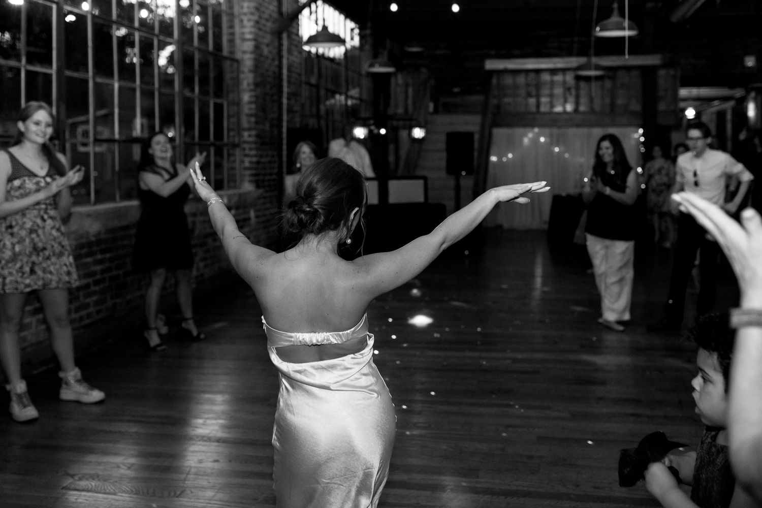 Fun-filled wedding reception with guests dancing to live music.