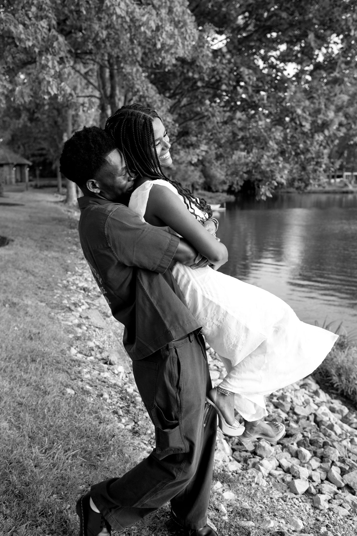 Newly engaged couple, Belle and Chadrack, holding hands and smiling during their proposal photoshoot in Kentucky.