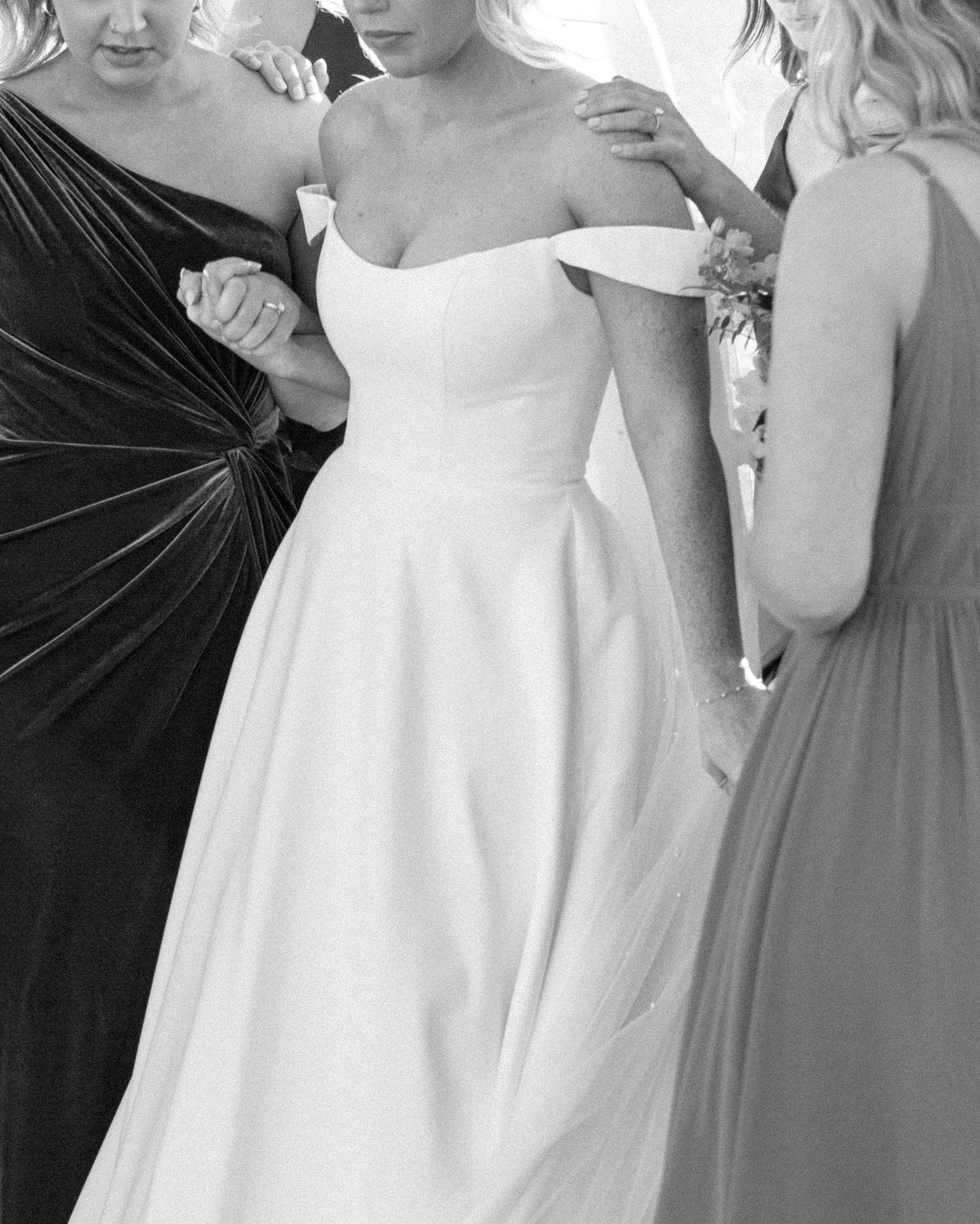Bridesmaids praying around the bride in a touching wedding moment
