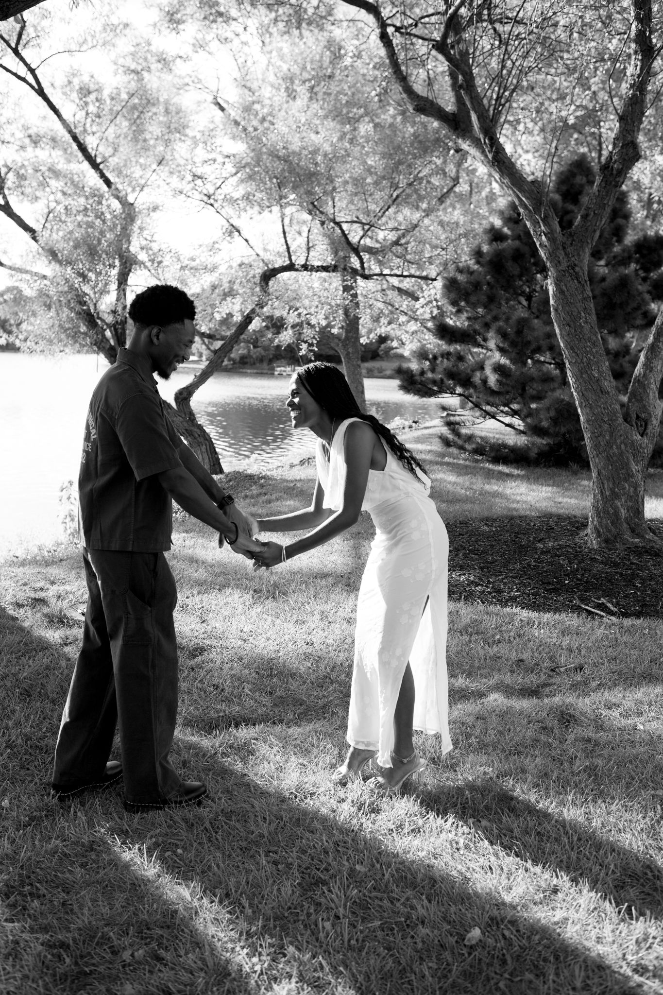 Engaged Black couple sharing a quiet, loving moment under tall trees in Lexington, KY.